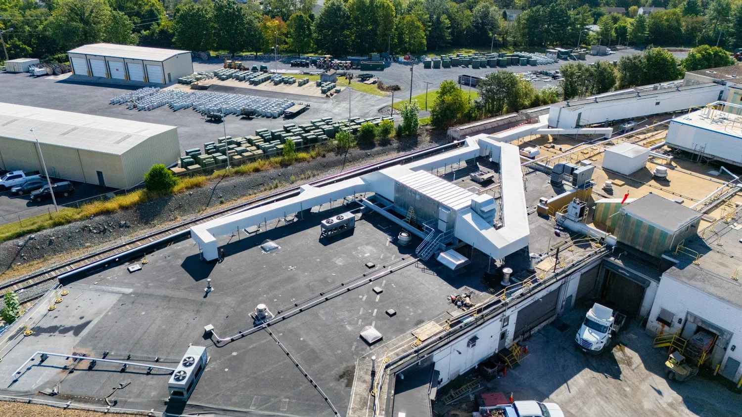 Aerial view of an industrial plant roof with a new insulated metal panel duct system