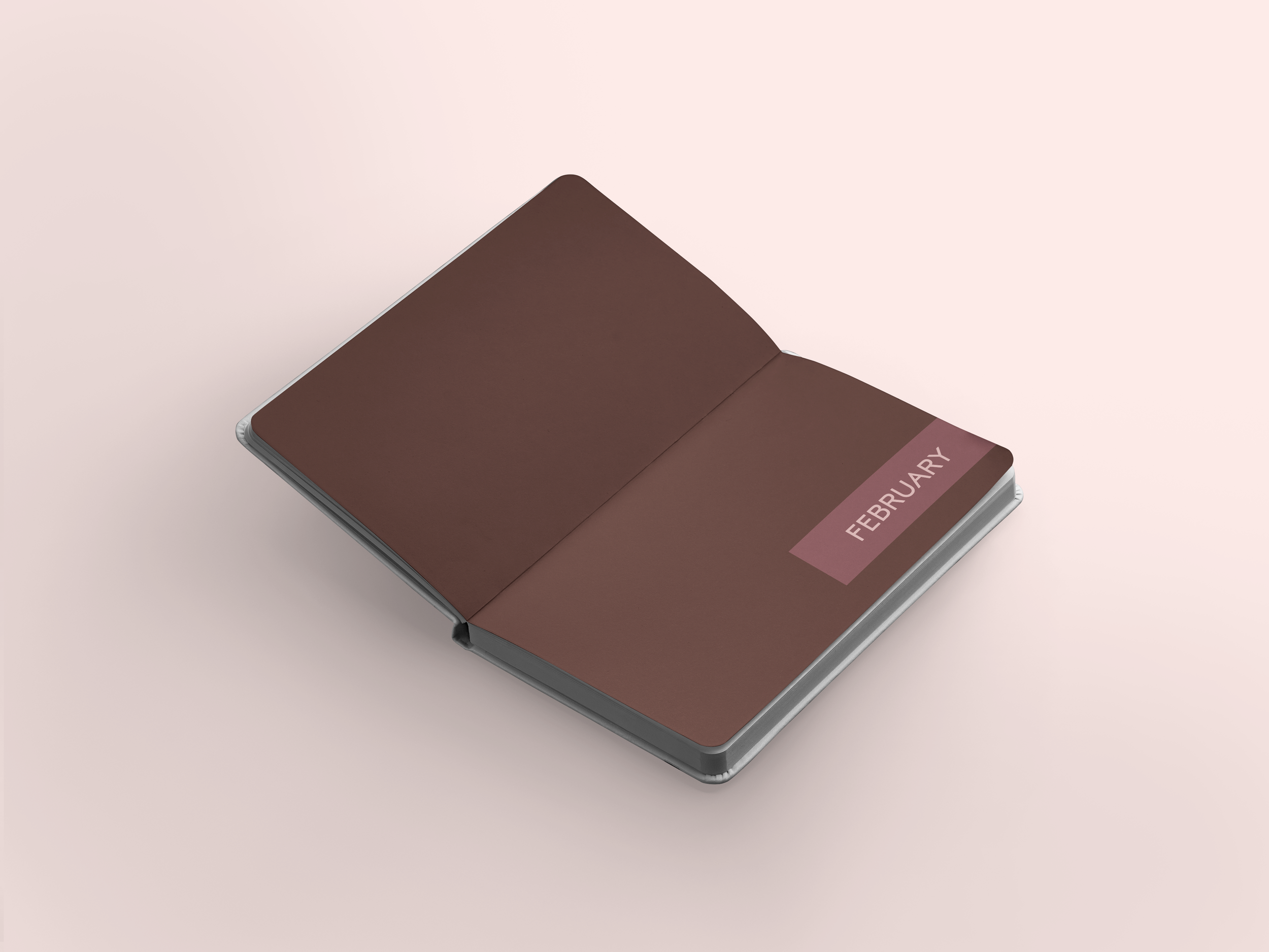 Open PCOS planner notebook displaying the month of February on a pink surface.