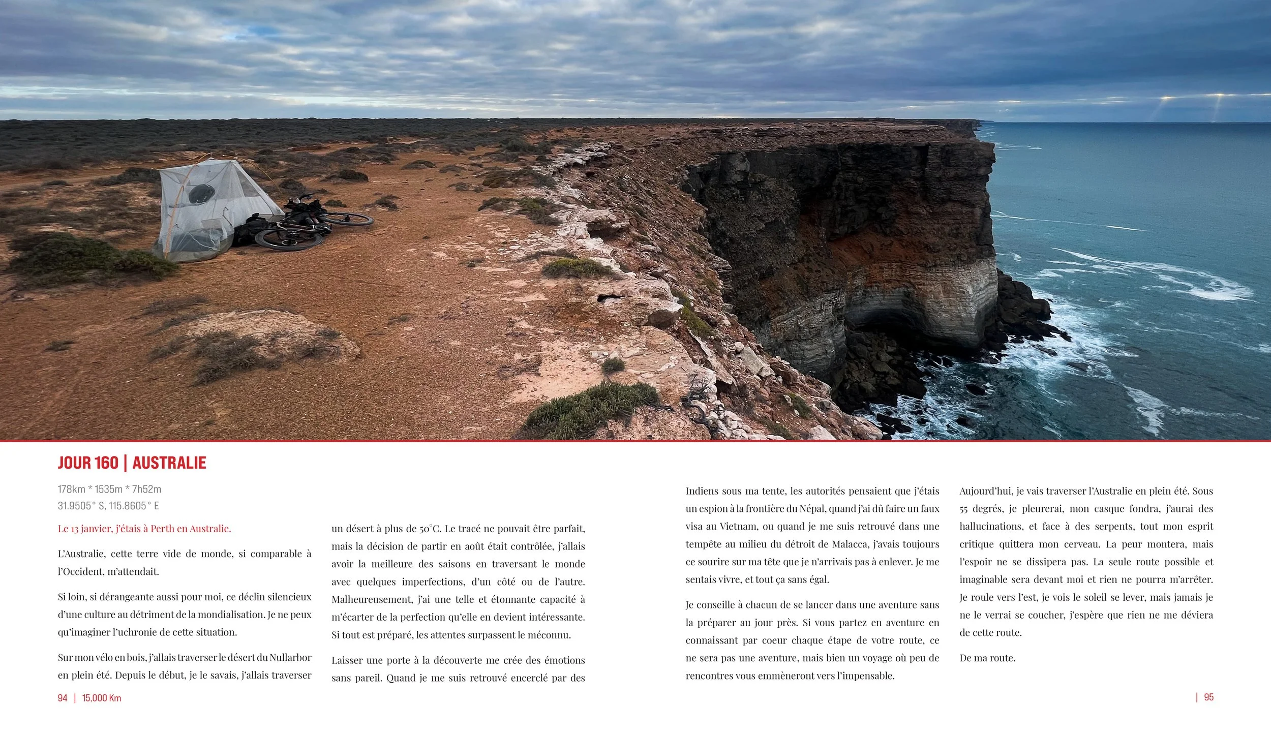 A desert cliffside with a tent and mountain bikes on a dirt trail overlooking the ocean during daytime.