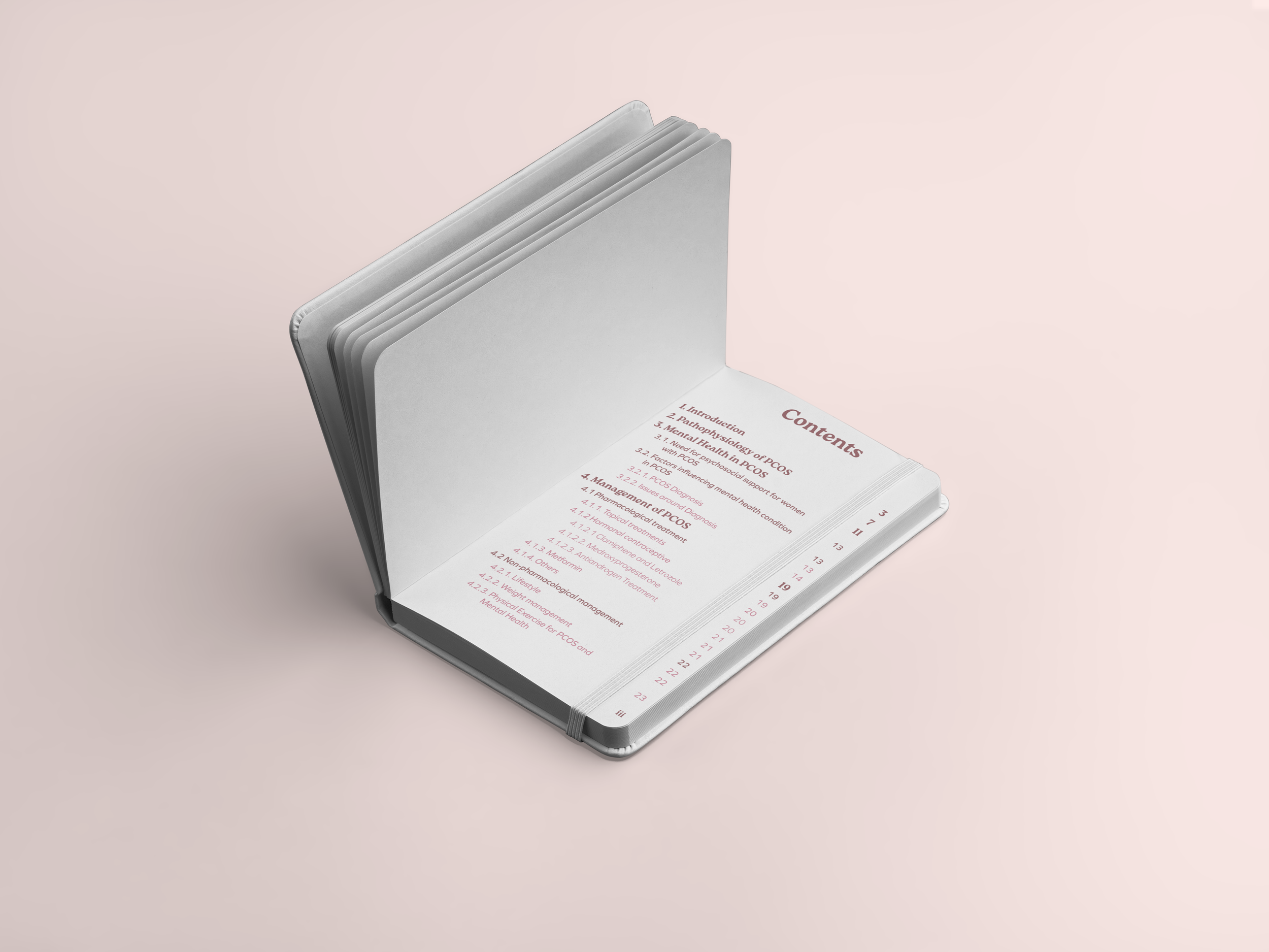 Open PCOS planner notebook with tabbed pages on pink background, displaying a table of contents for a book.