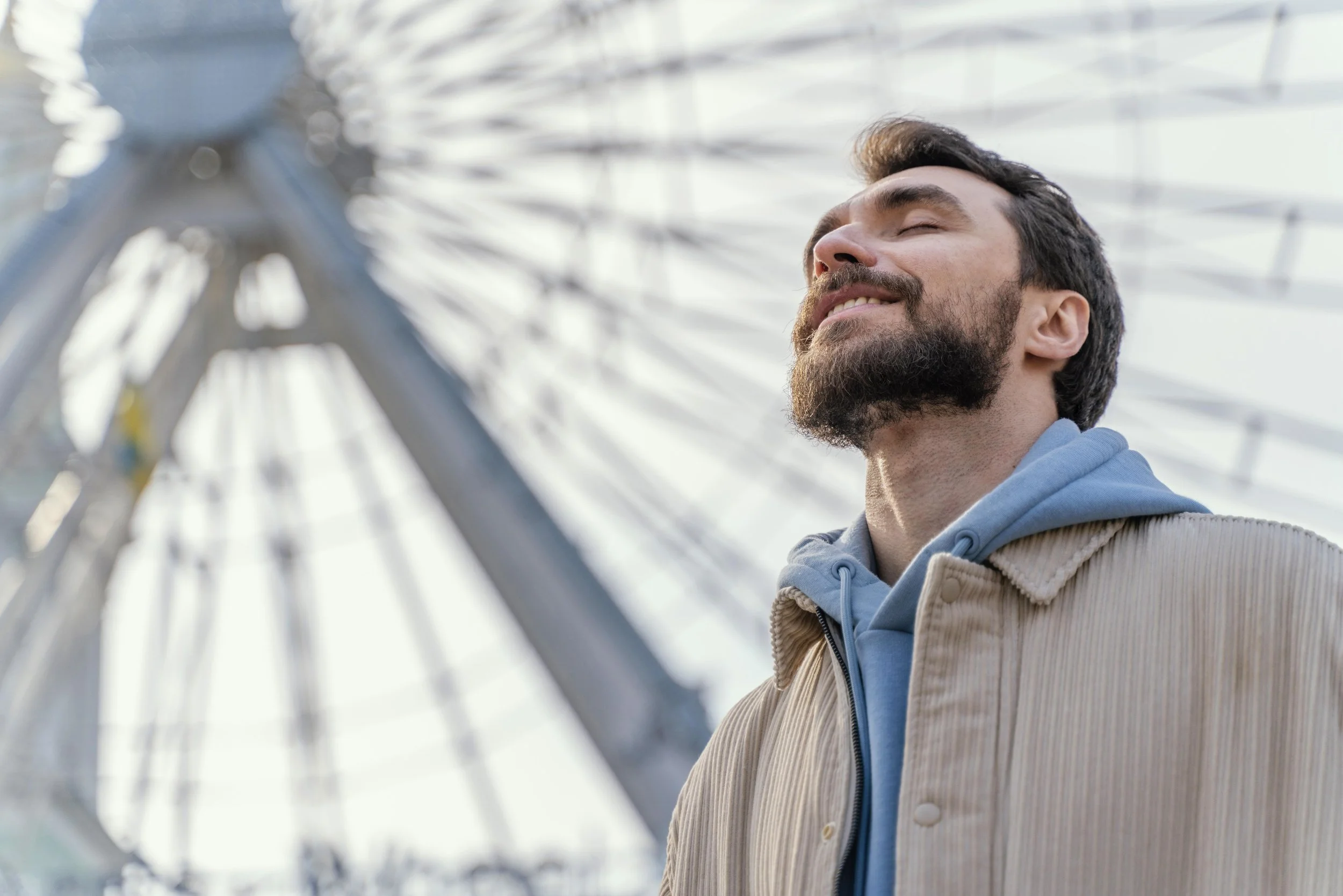Man standing in sunlight reflecting on confidence and new beginnings in life after divorce
