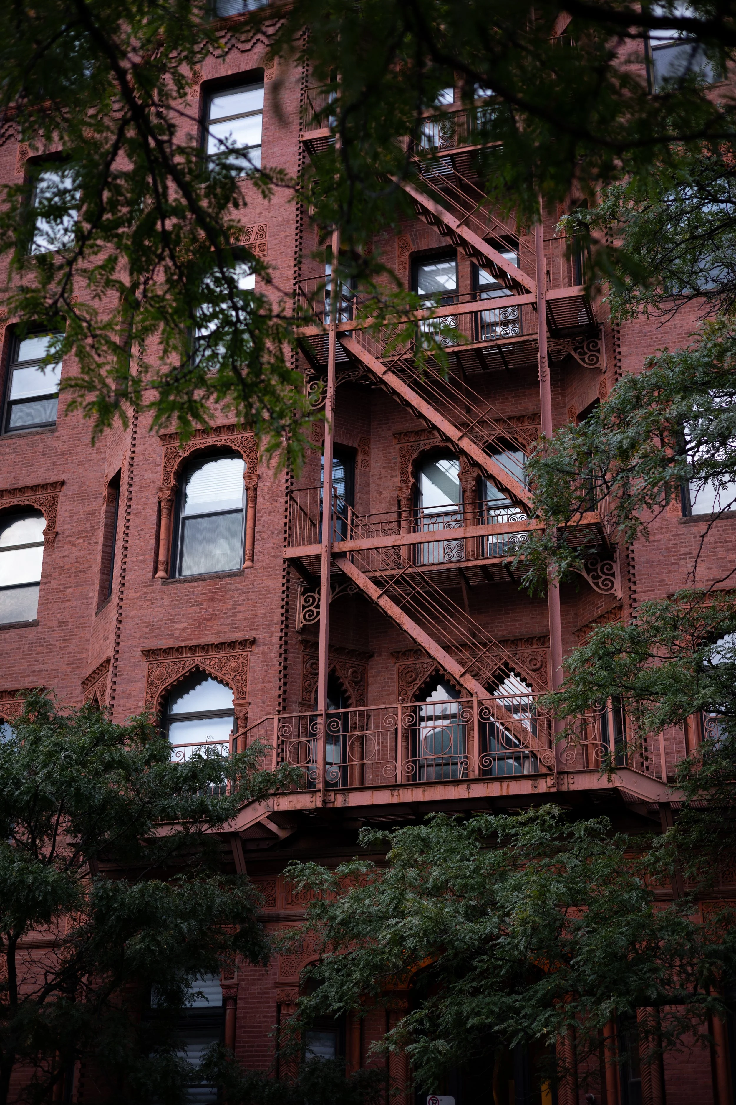 A building facade framed in by trees in Boston, MA.