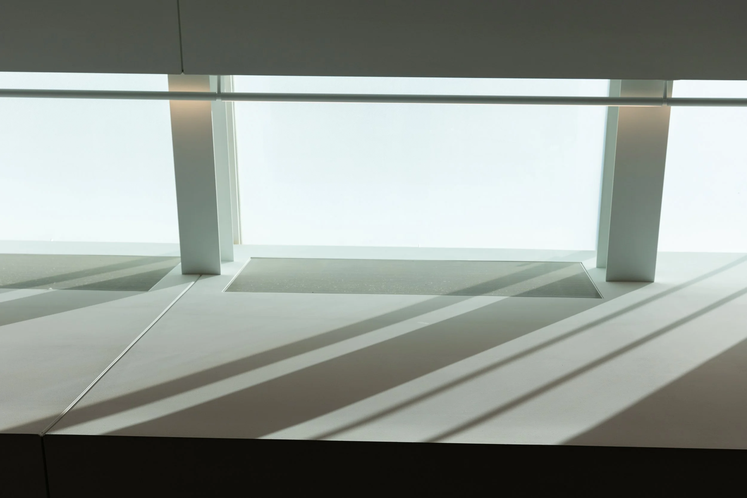 An abstract view of shadows and light coming into a skylight in a building