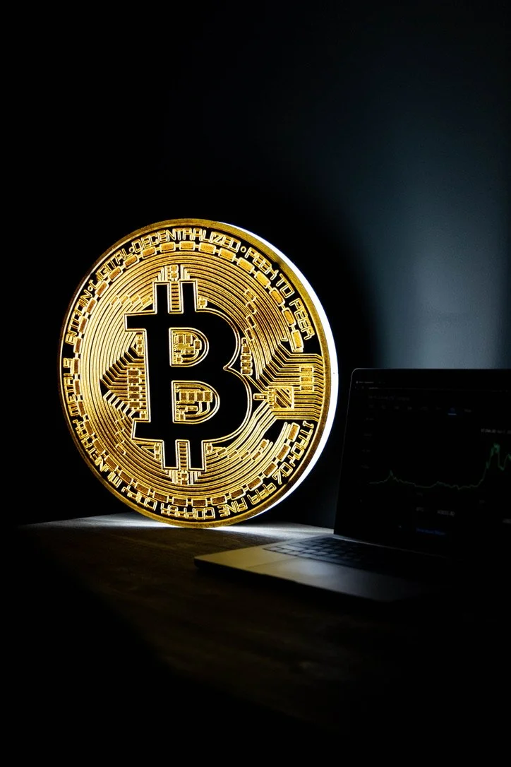 An illuminated Bitcoin LED sign sitting on a table