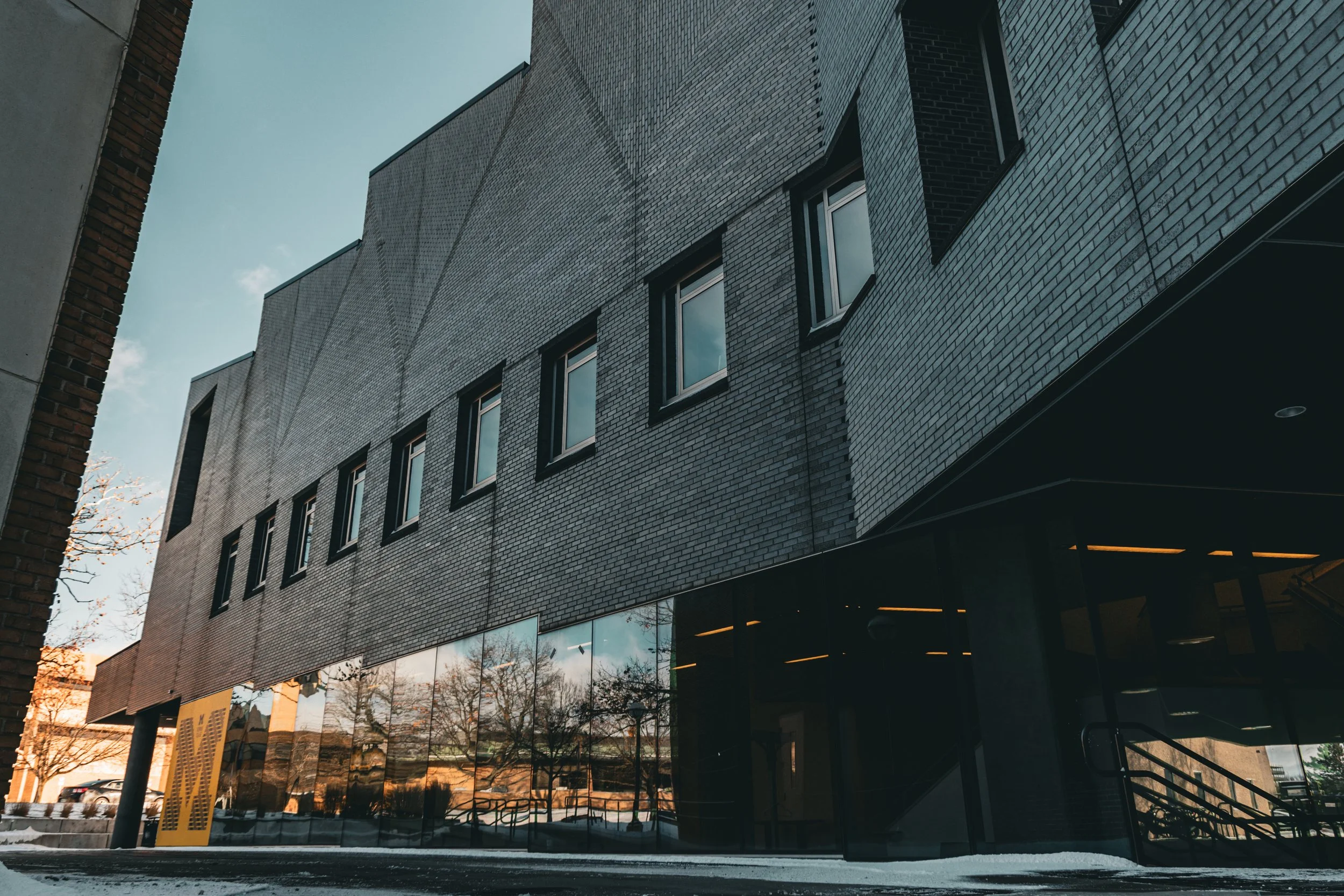 A low angle view of a building with a sawtooth designed roof