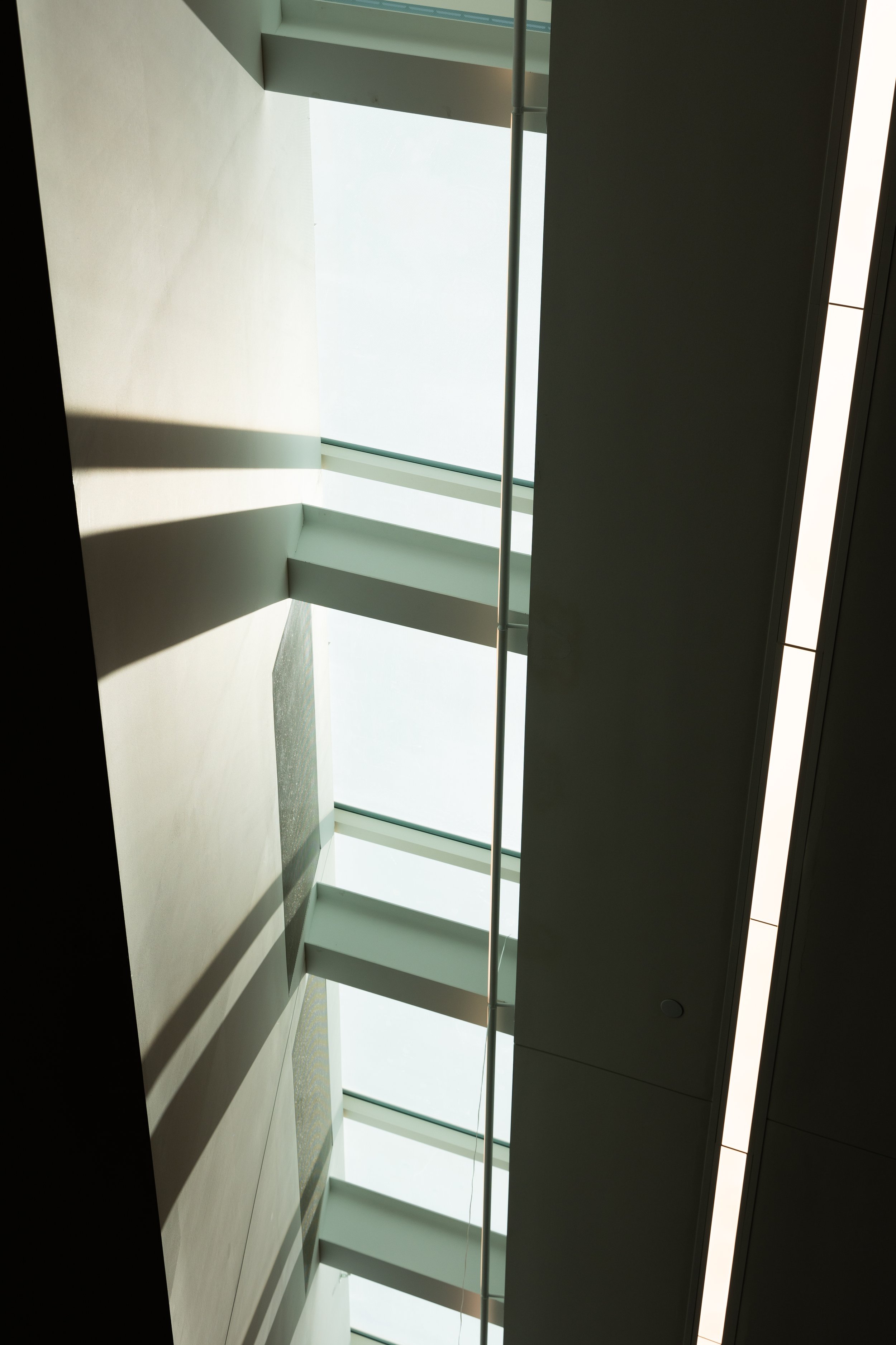 An abstract view of shadows and light coming into a skylight in a building