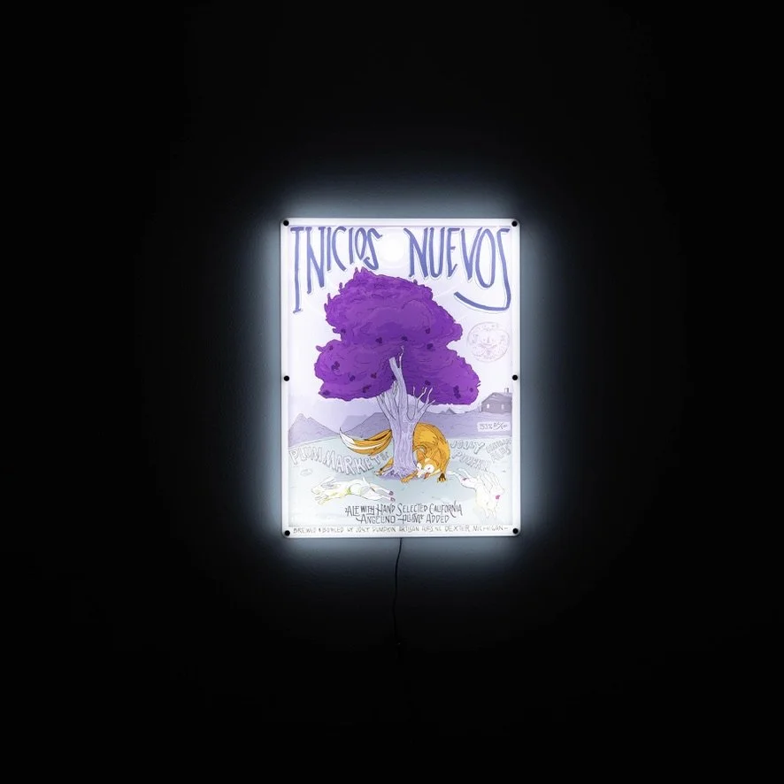 An illuminated LED sign with a purple tree