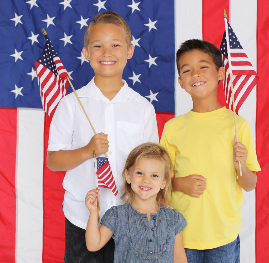 Children holding American flags representing families supported by United With Care’s local, community-based mission