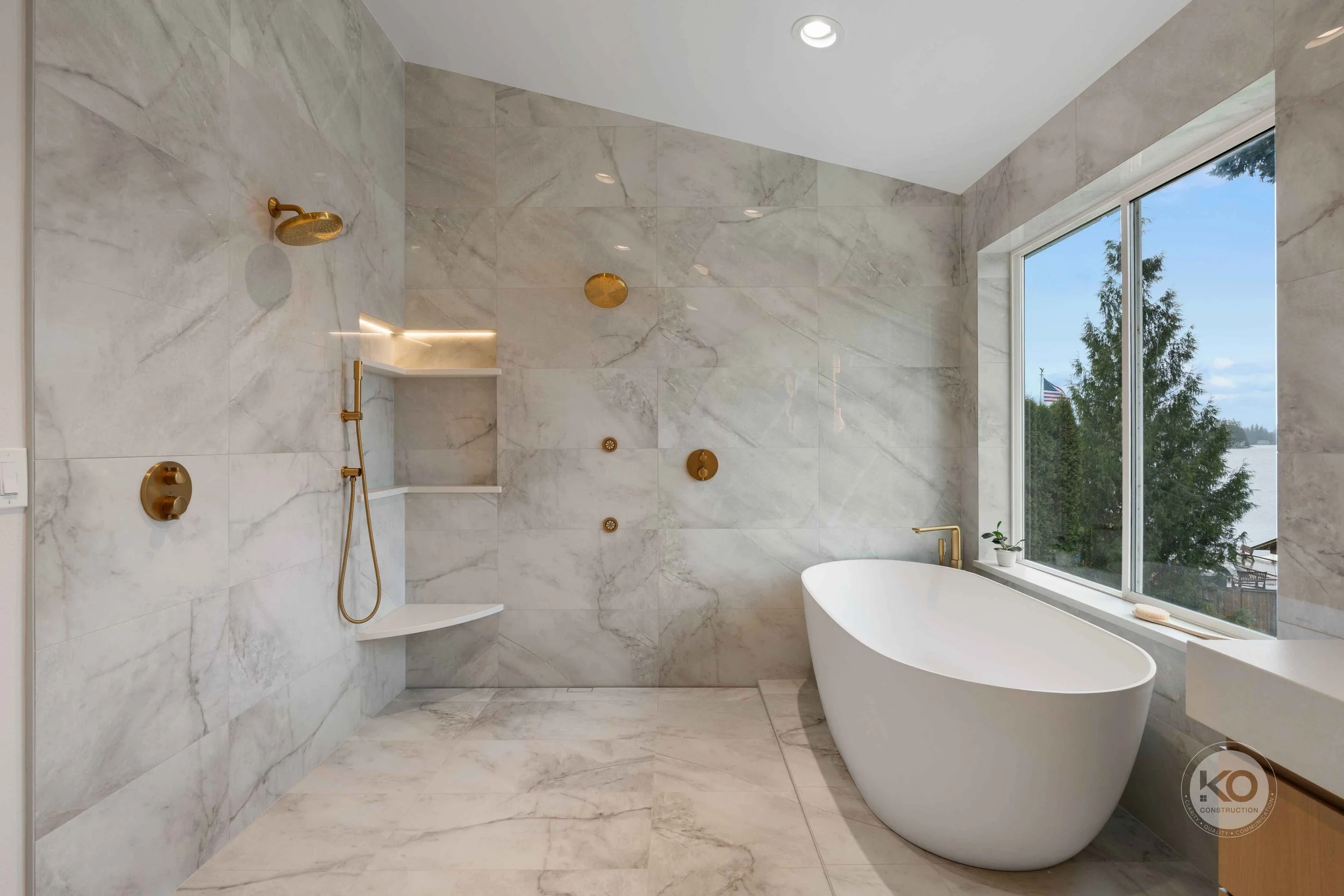 Custom walk-in shower and freestanding soaking tub in a Lake Tapps primary bathroom remodel by KO Construction.