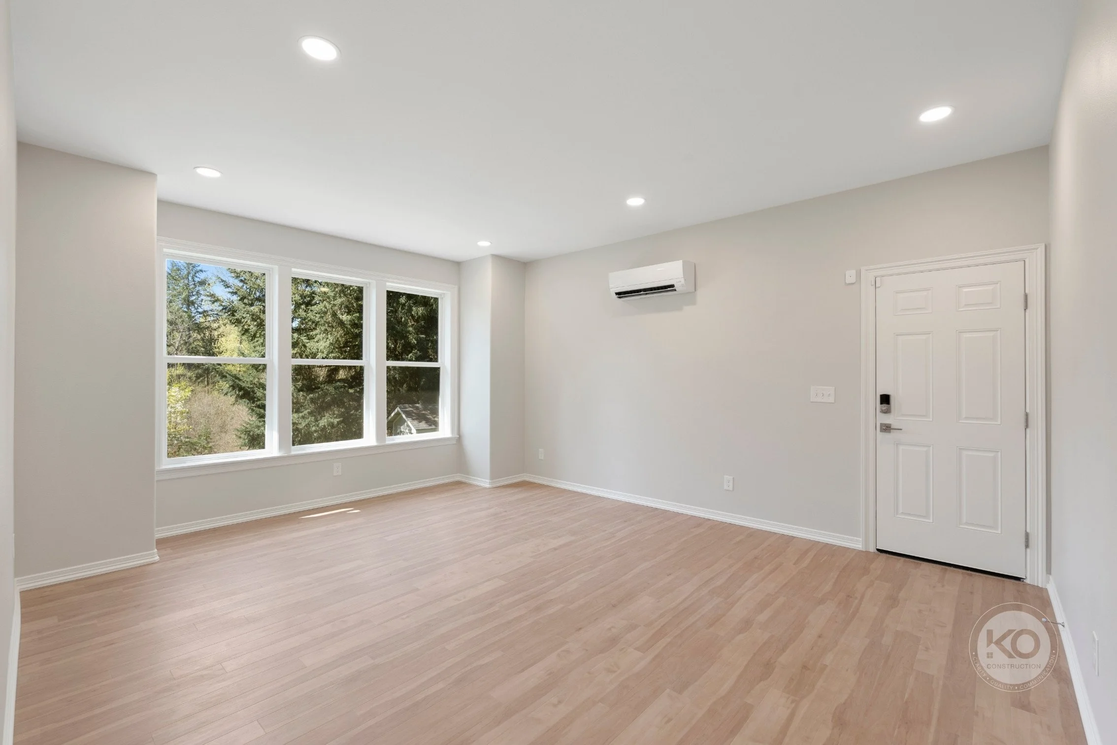 New primary bedroom addition with wide-plank flooring in Lake Tapps