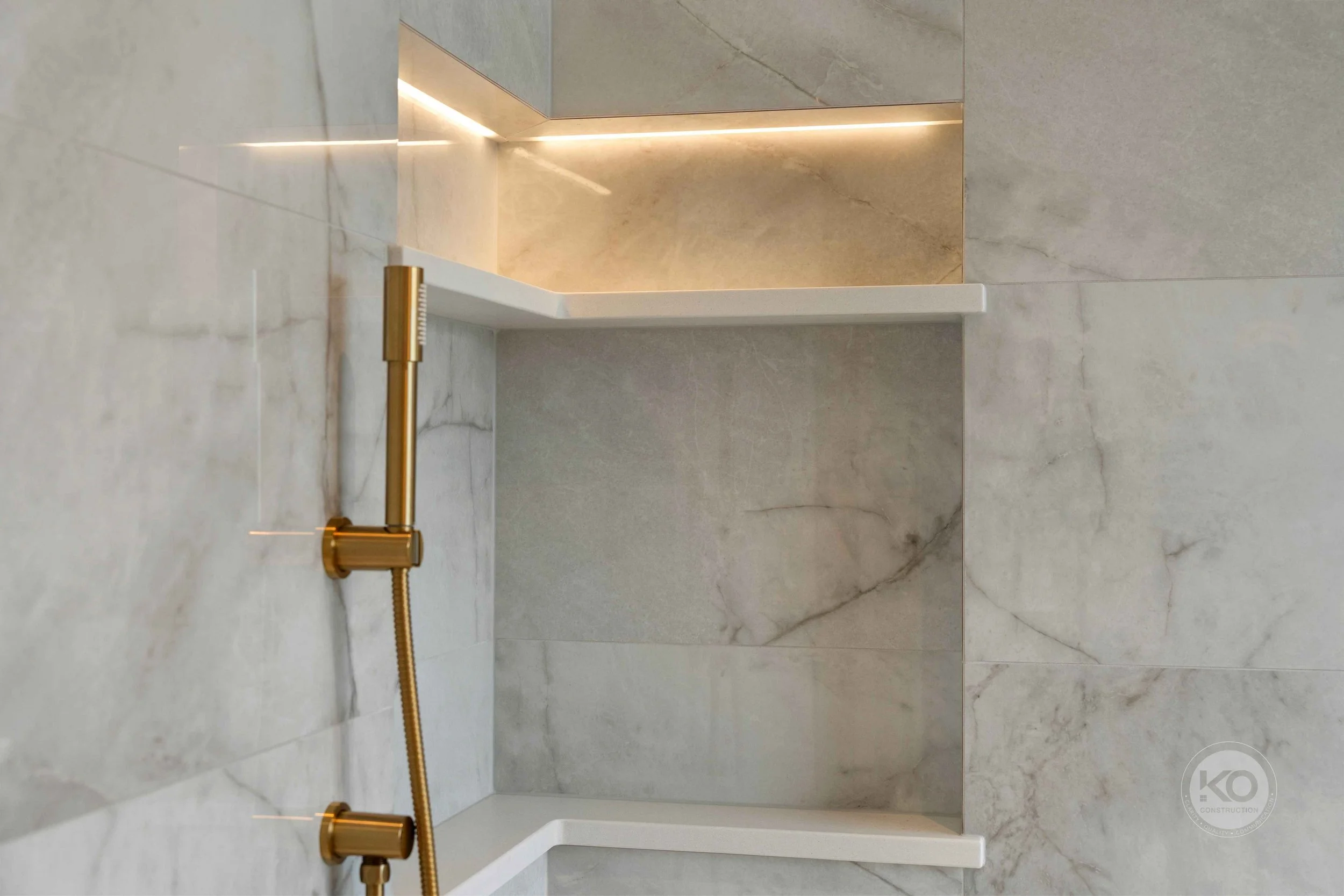 Custom shower niche with integrated lighting in a luxury primary bathroom remodel in Pierce County, WA.