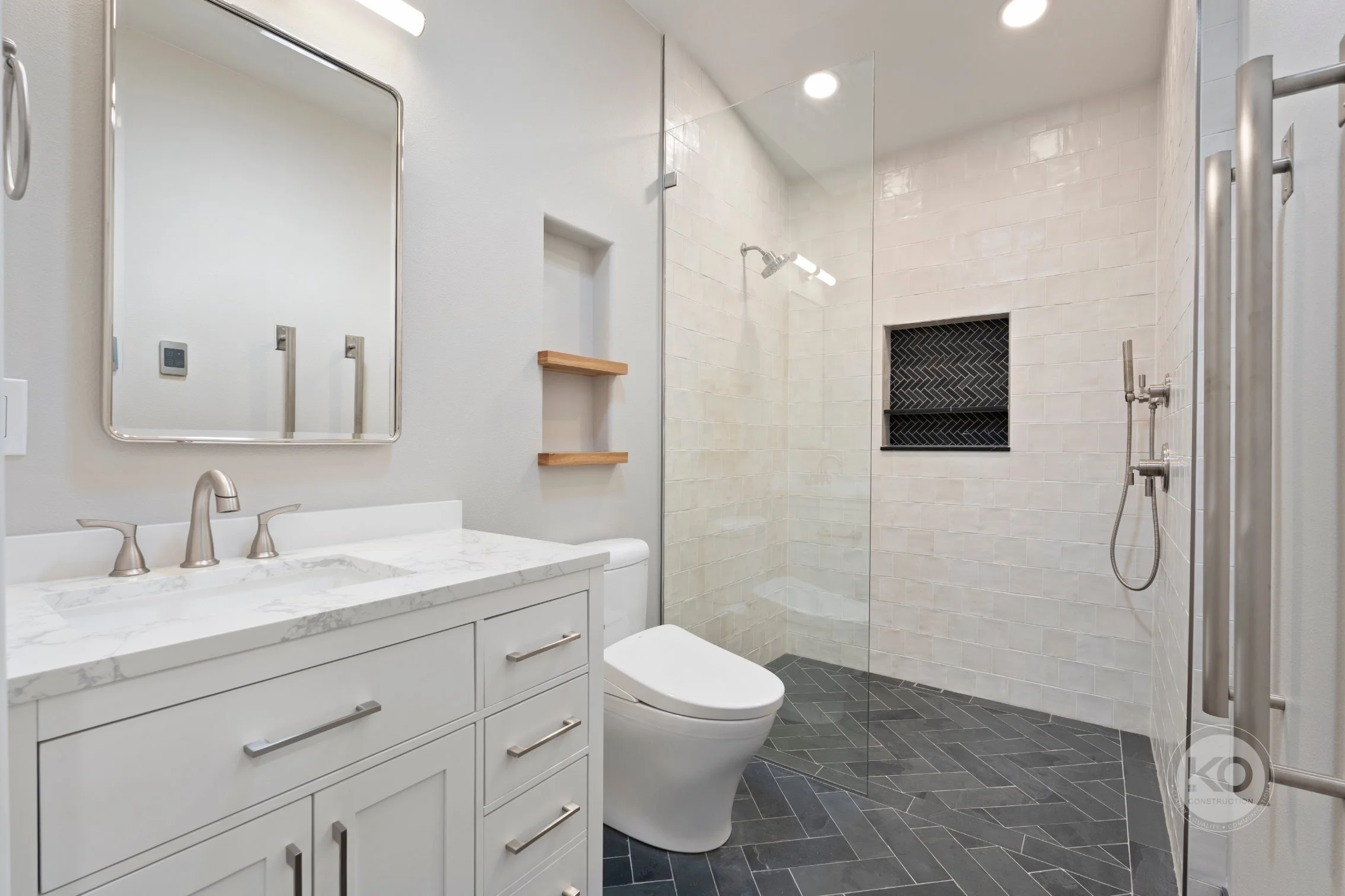 Custom tiled shower niche with herringbone accent tile in Lake Tapps bathroom