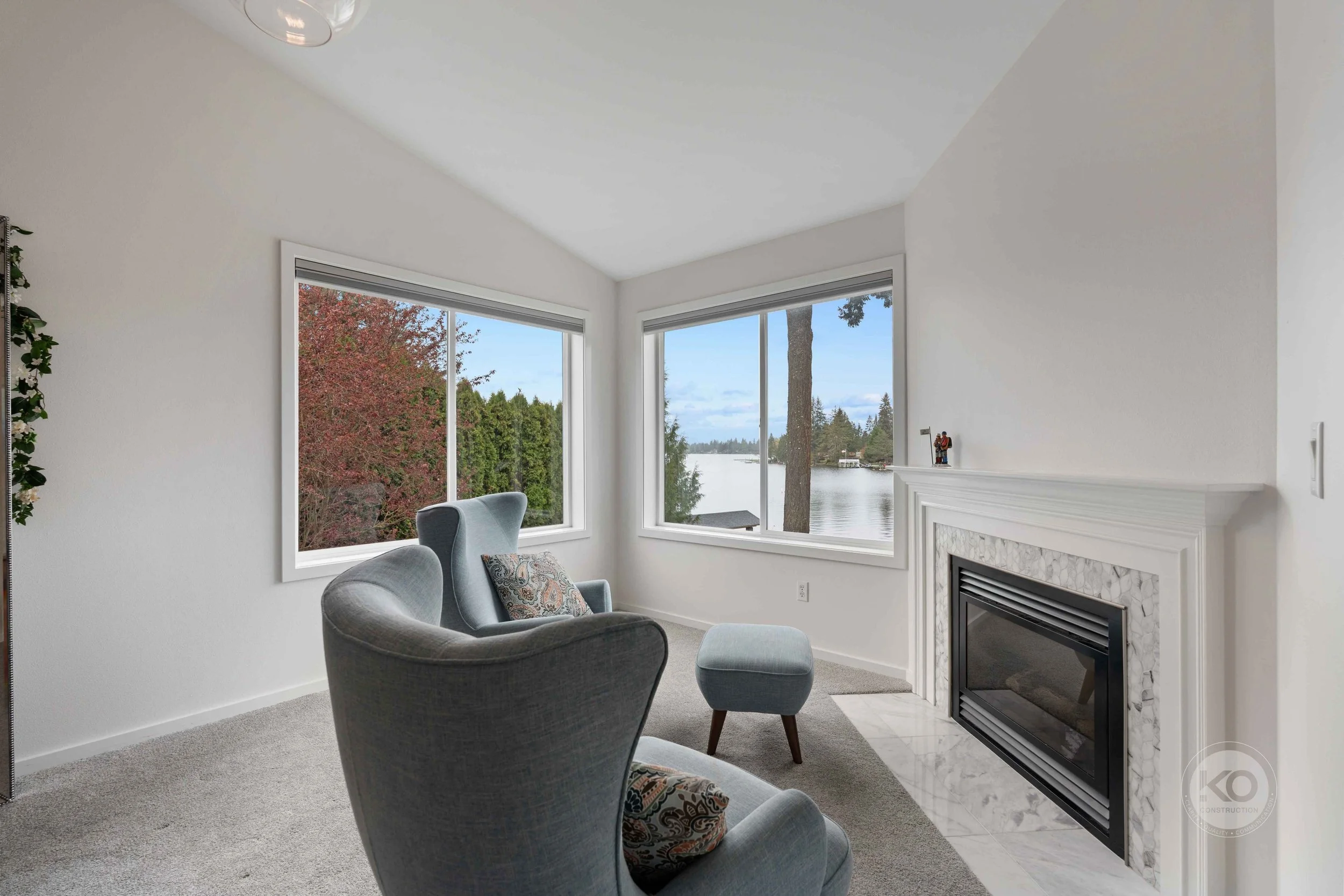Primary suite sitting area with fireplace in a luxury Lake Tapps home remodel.