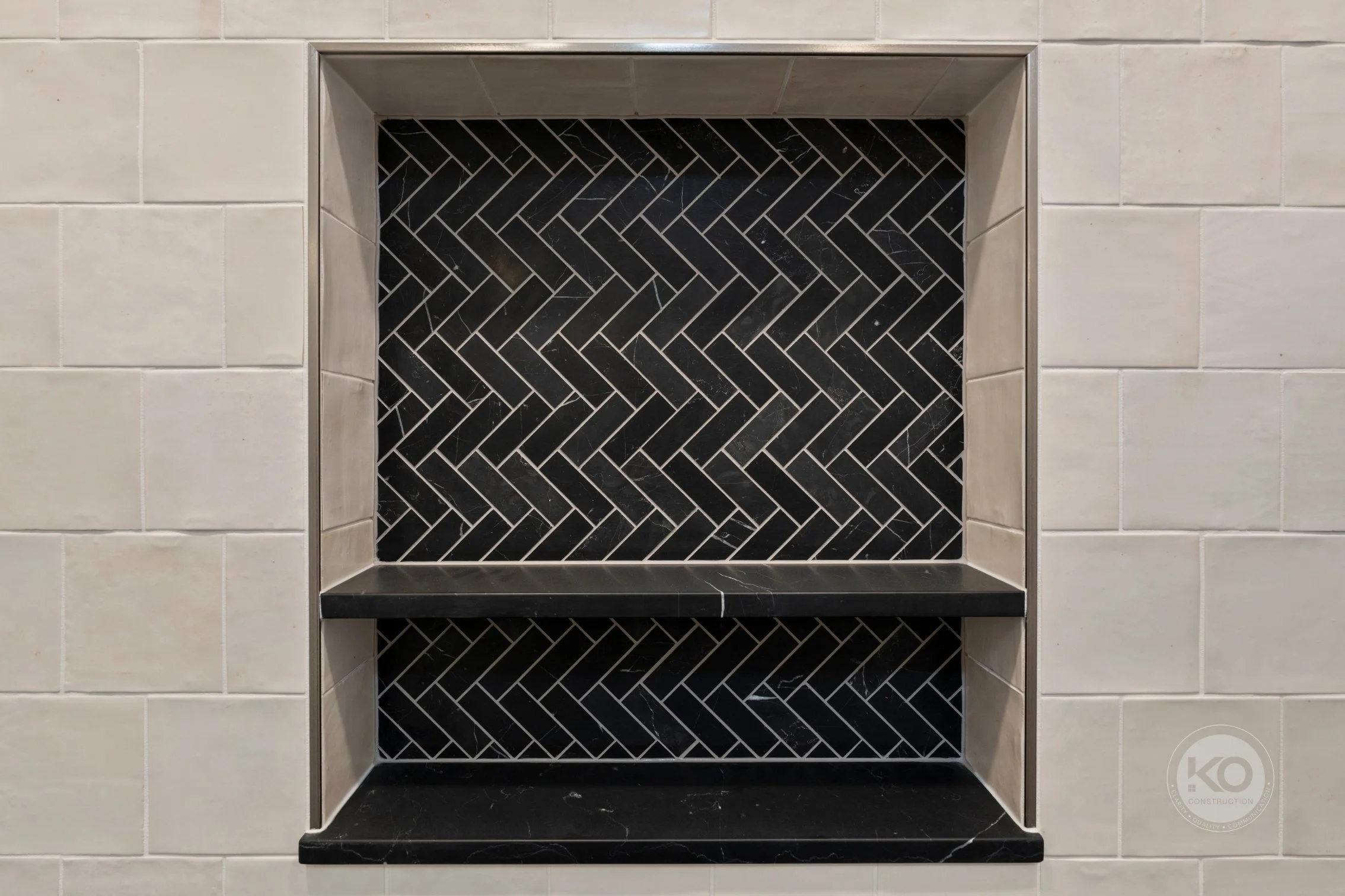 Close-up of custom herringbone tiled shower niche in Lake Tapps bathroom