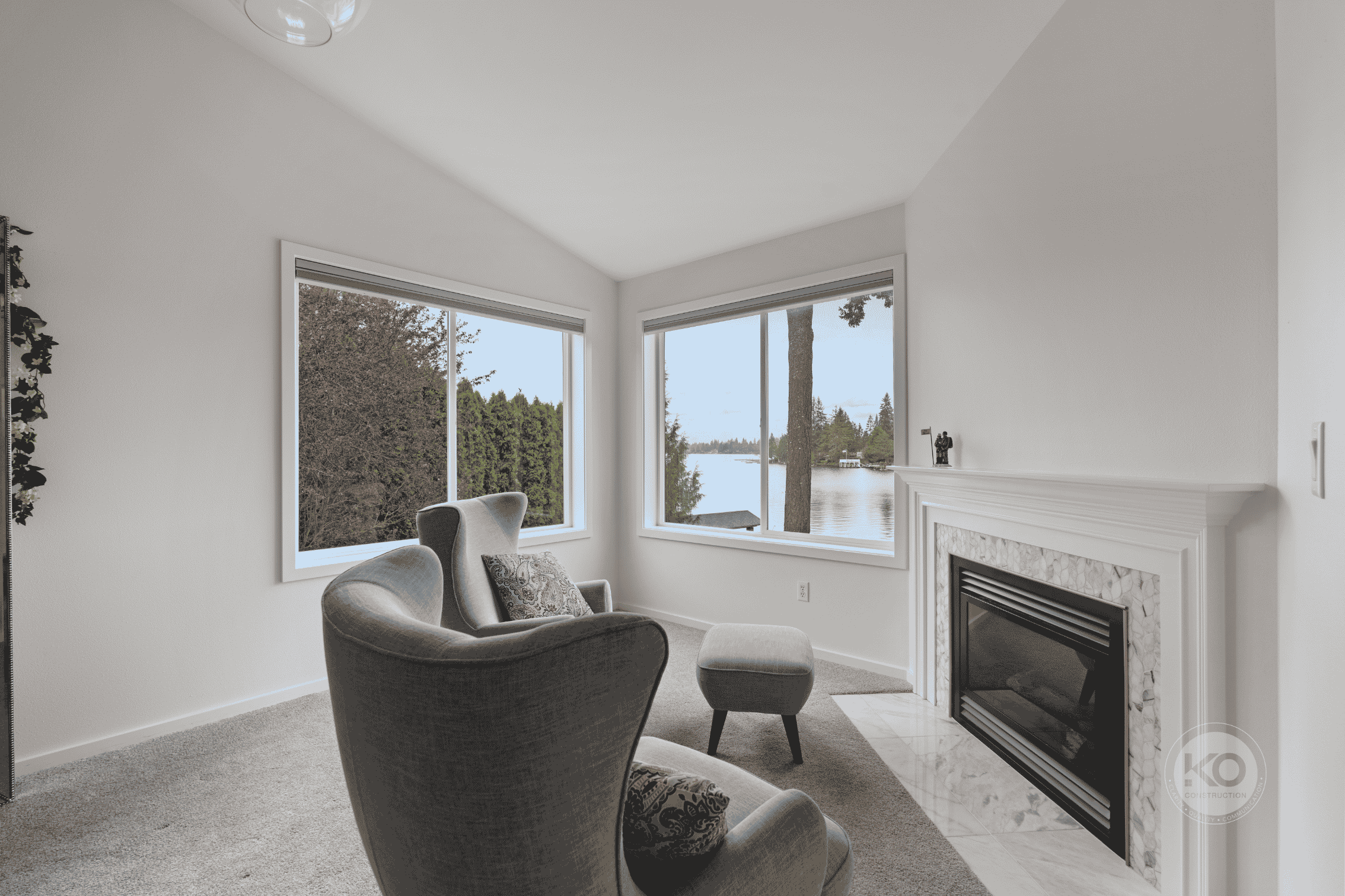 Primary suite sitting area with fireplace in a luxury Lake Tapps home remodel.