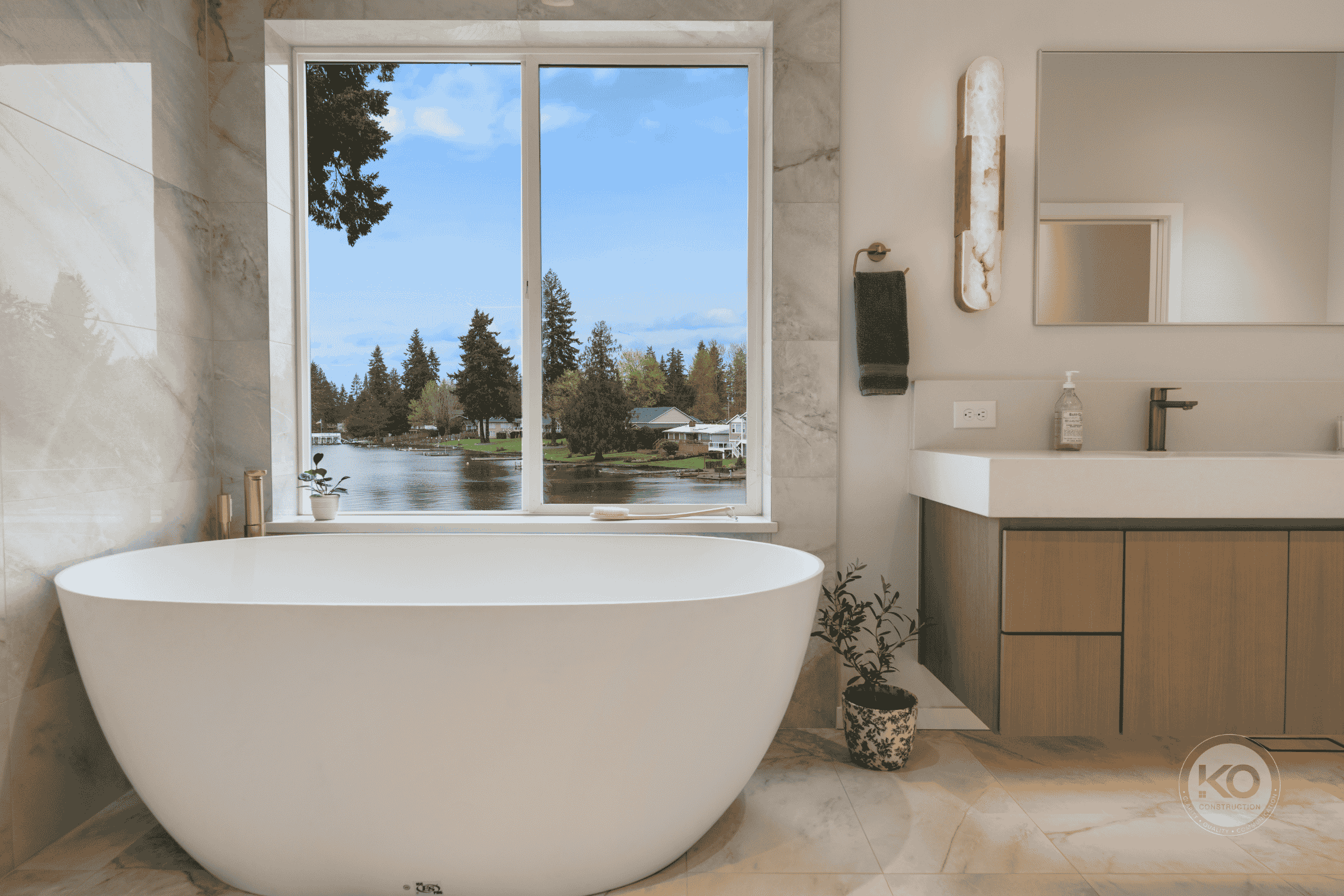 Luxury primary bathroom remodel in Lake Tapps, Washington featuring a freestanding tub, custom vanity, and waterfront views.