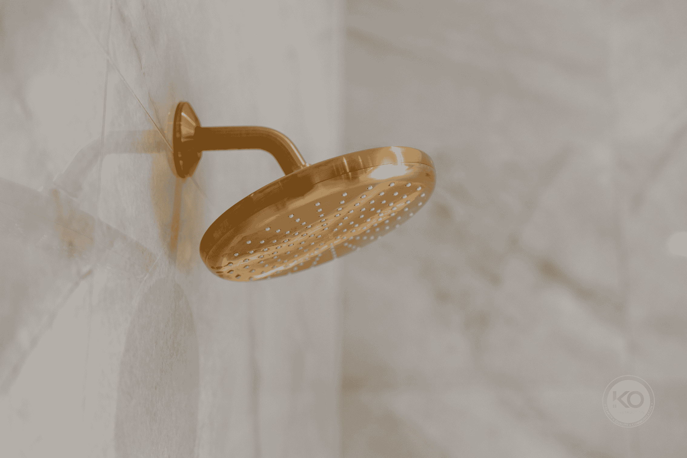 Brass rain shower fixture detail in a luxury bathroom remodel near Tacoma, Washington.