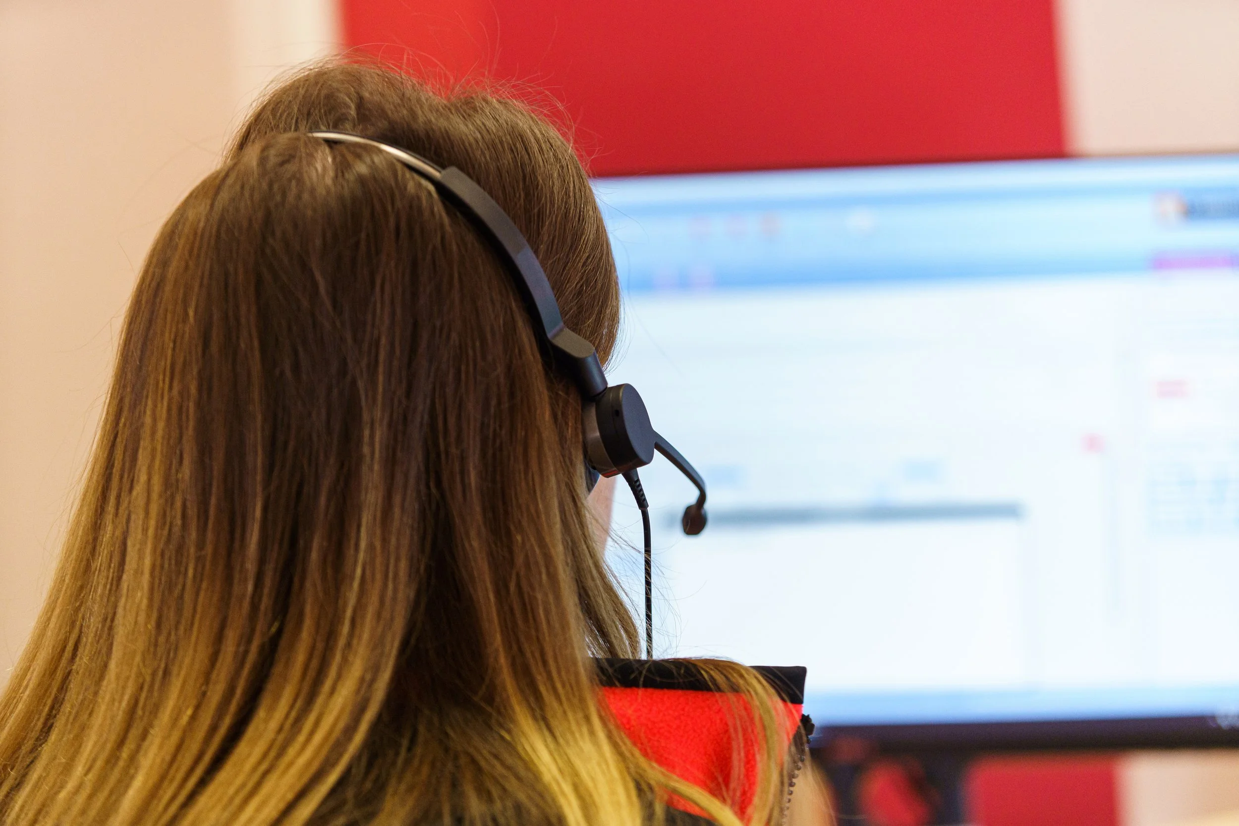 Person wearing headset using computer