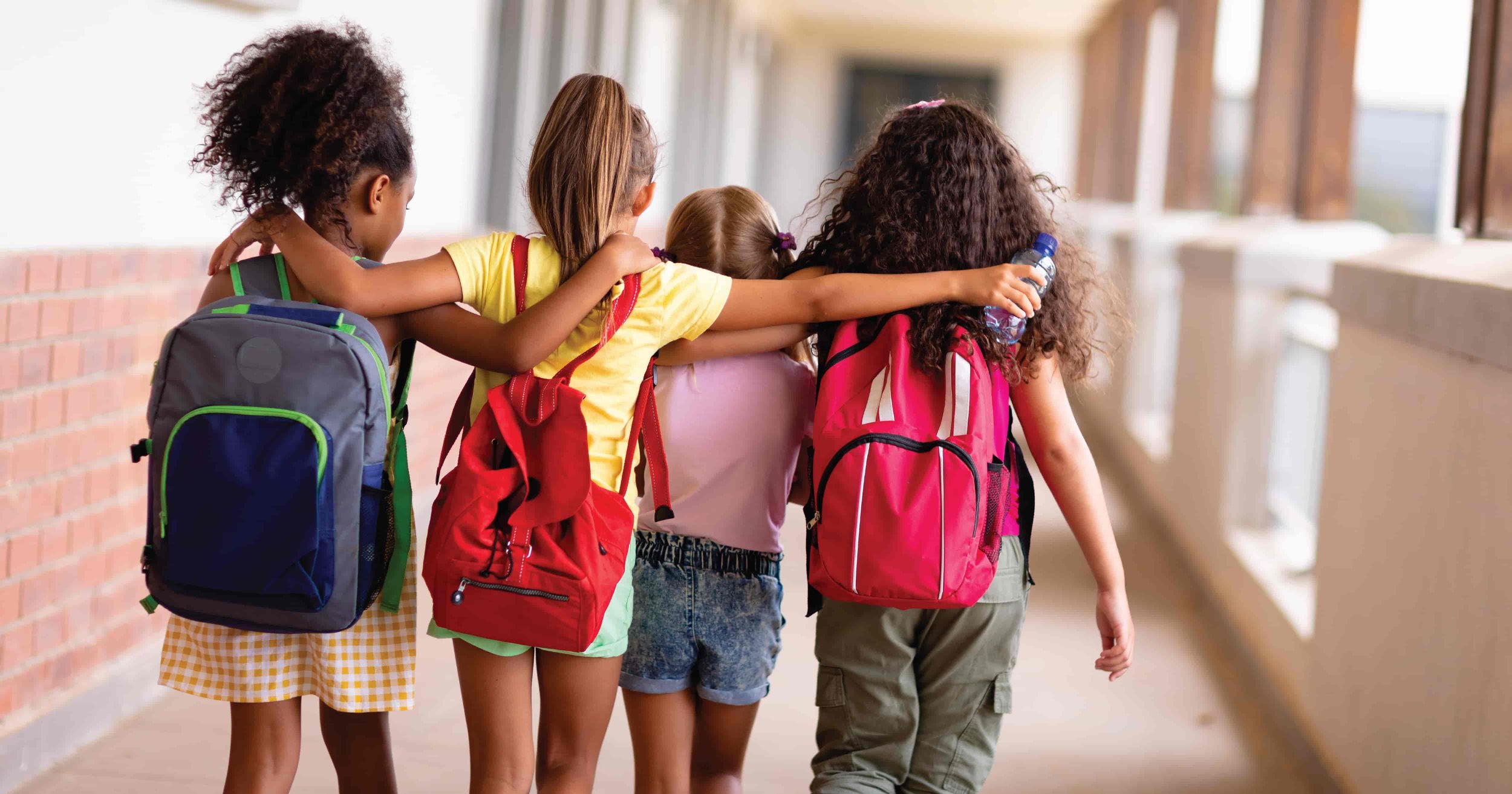 Group of kids walking with backpacks