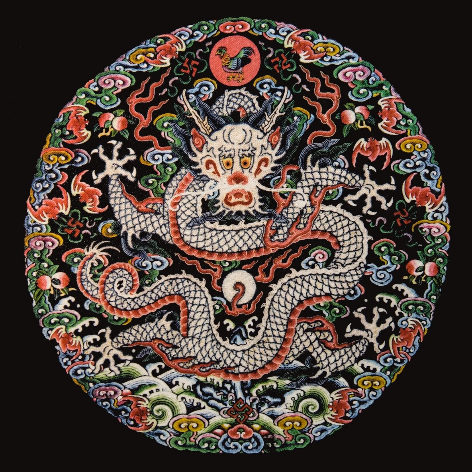 Colorful embroidered patch of a Chinese dragon with a fierce face, surrounded by clouds and floral patterns on a black background.