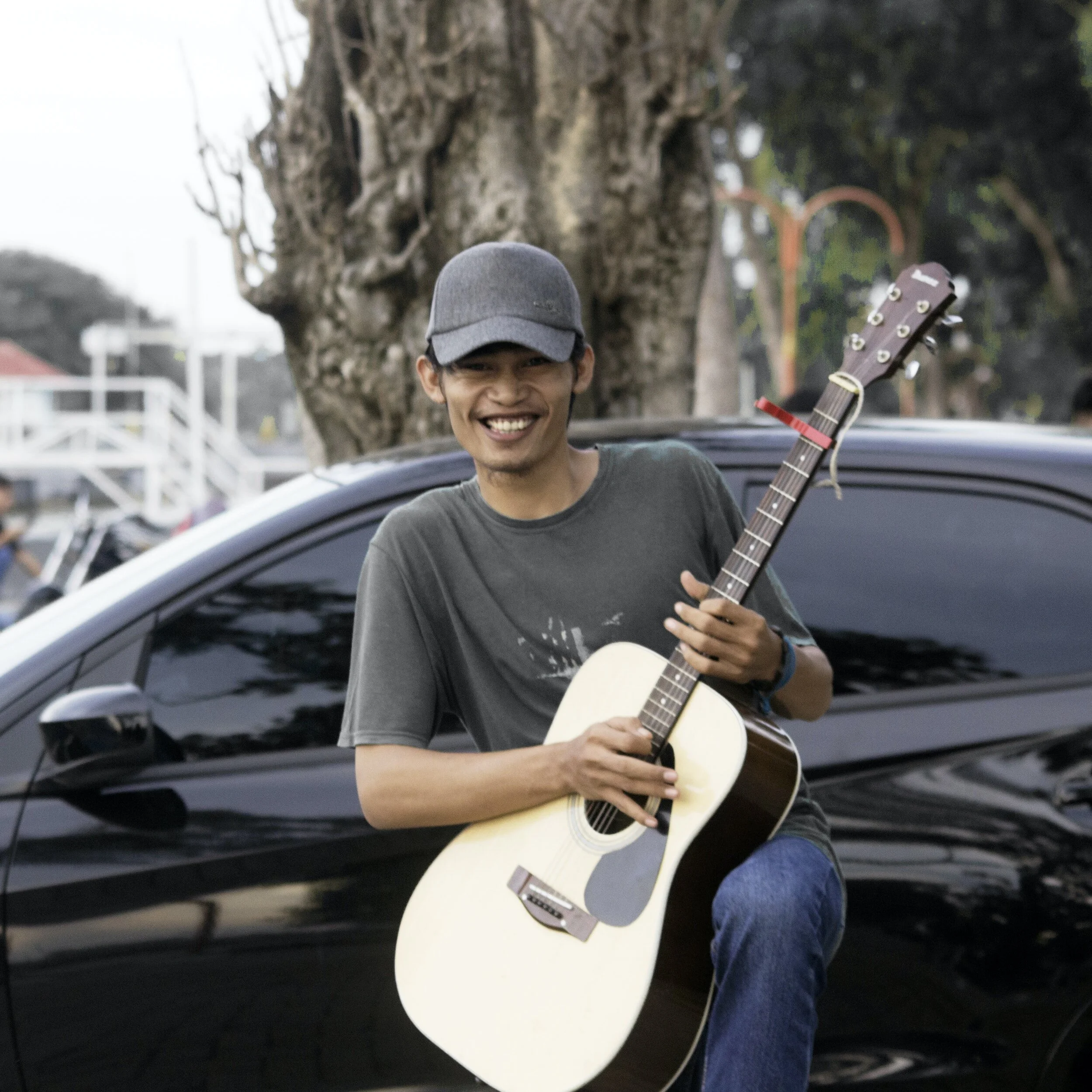 A young musician holding a guitar