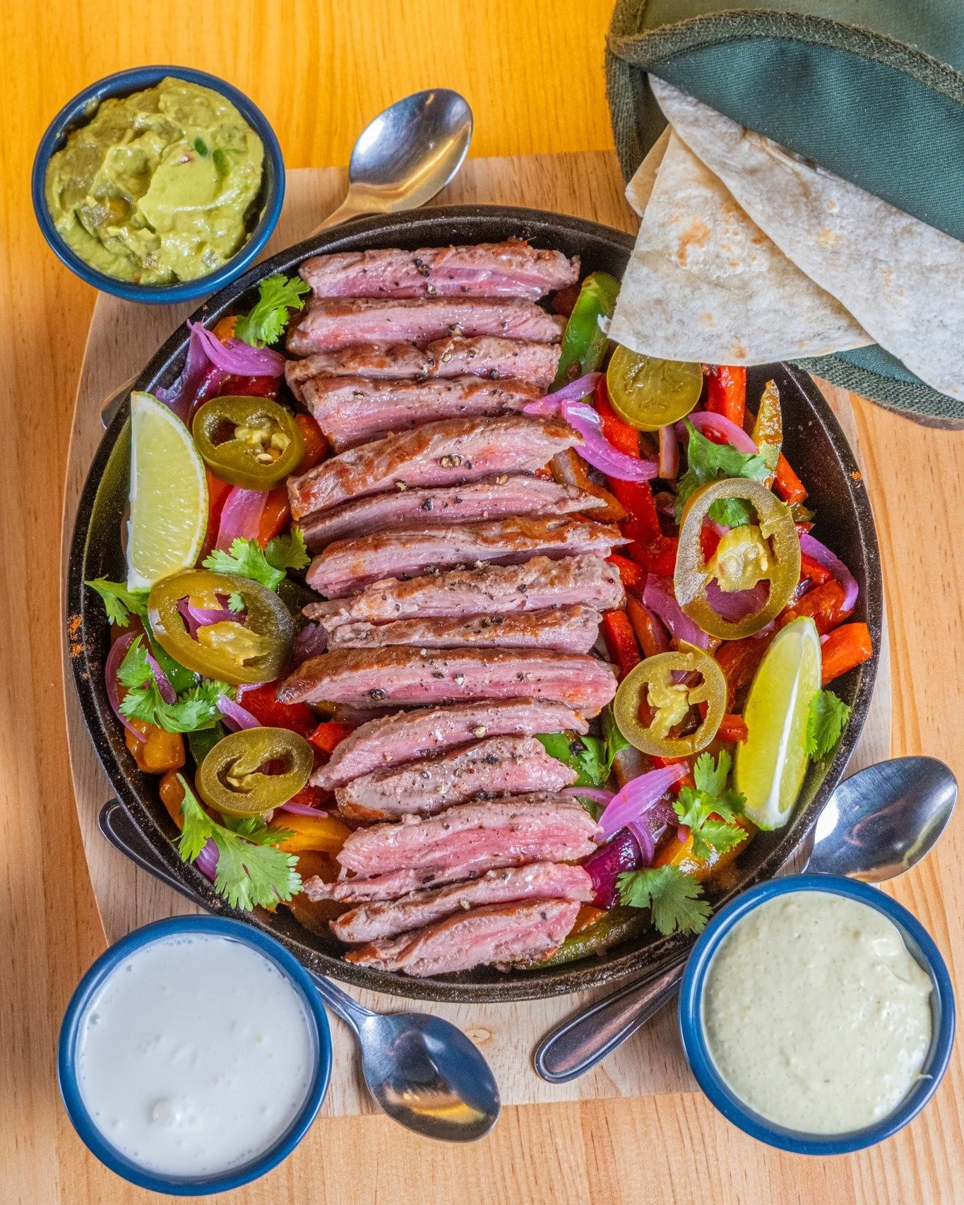 ⚠️ WARNING: May cause extreme hunger! 🤤

🥩 Hear that sizzle? That's our famous Steak Fajitas making their grand entrance!

🔥 We take tender, marinated Hanger Steak and serve it piping hot alongside grilled peppers and onions on a sizzling skillet.