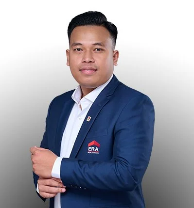 Professional man in a navy blue suit with ERA real estate logo, white shirt, posing with crossed hands against a white background.
