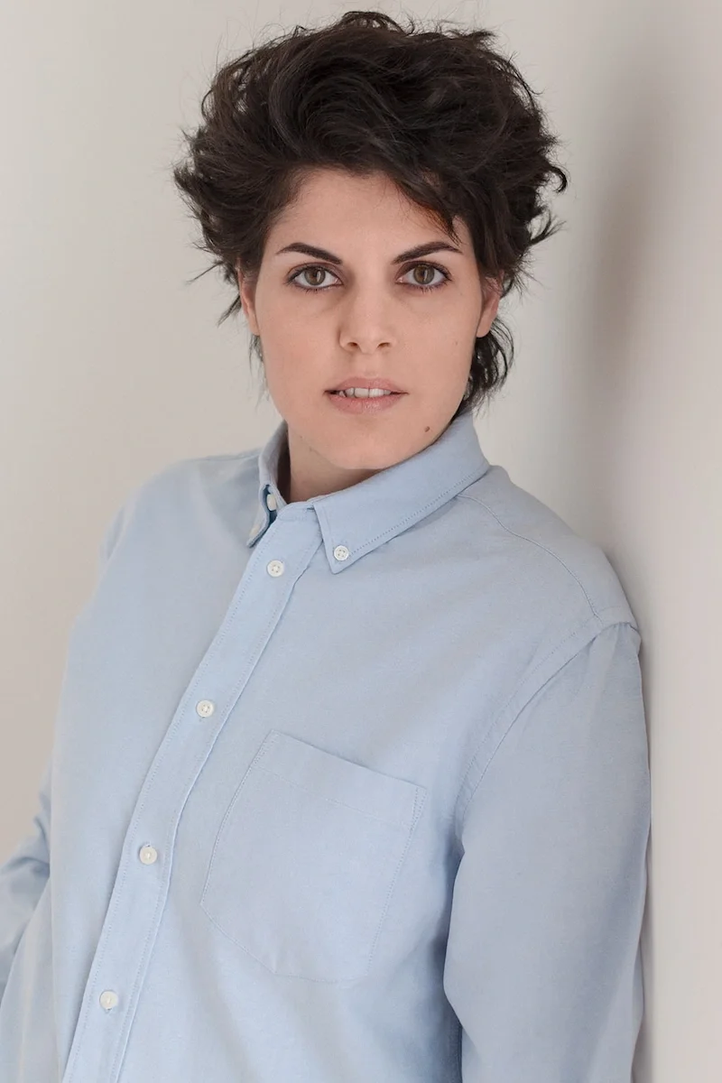 gallery_woman_lightblue_shirt_standing.webp