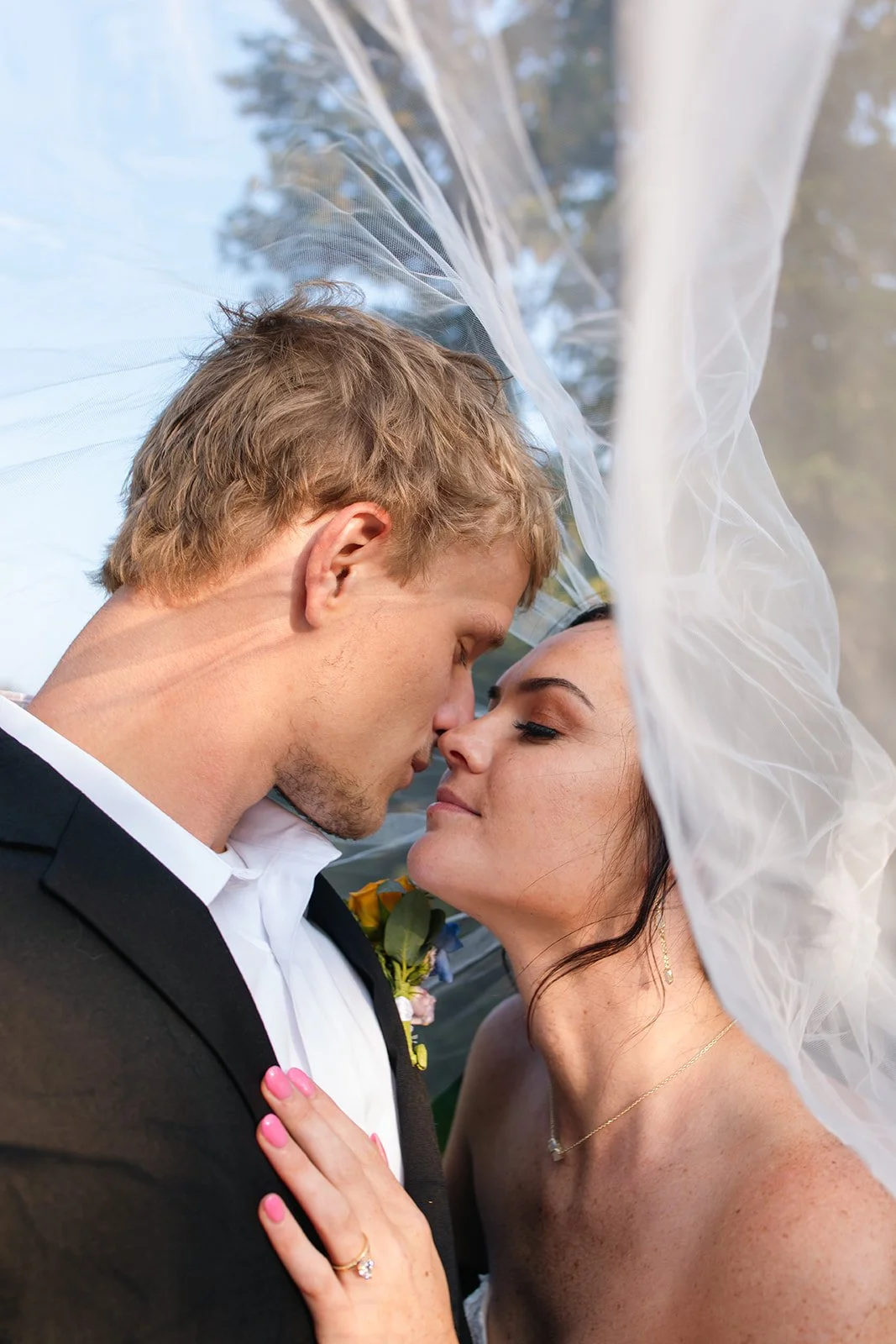 under the veil bride and groom portrait 