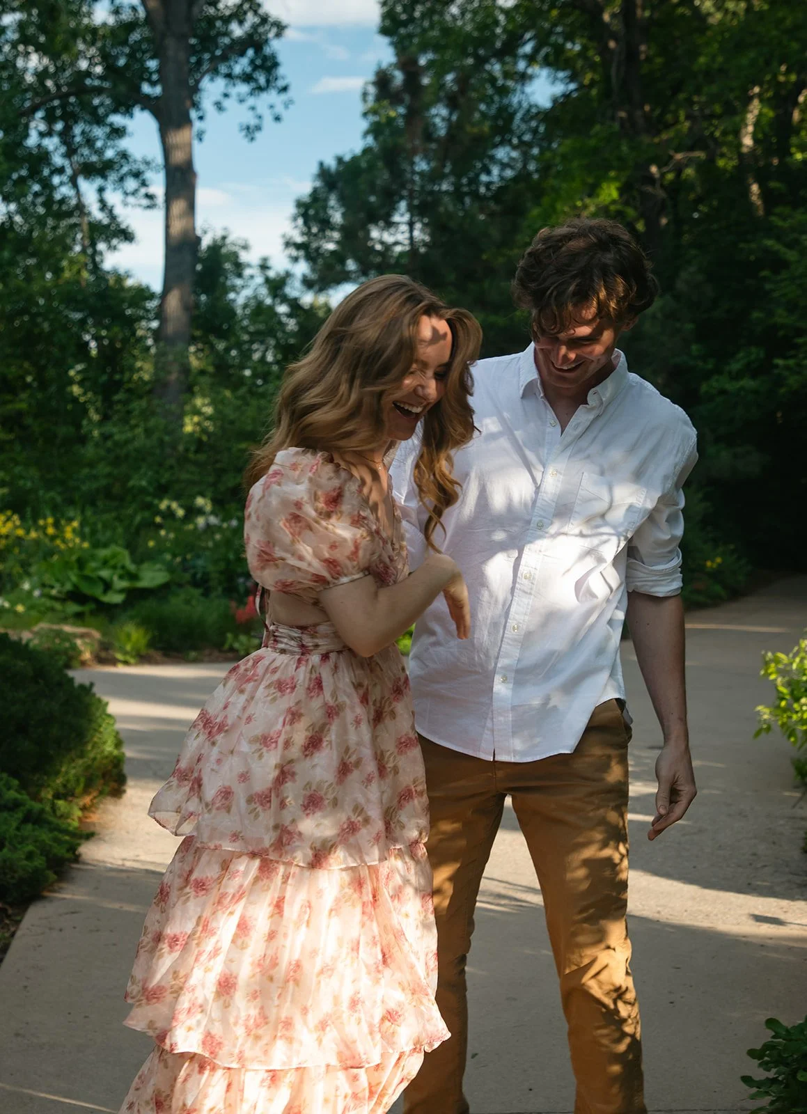 a candid engagement photo of a couple laughing together, taken by a Denver engagement photographer