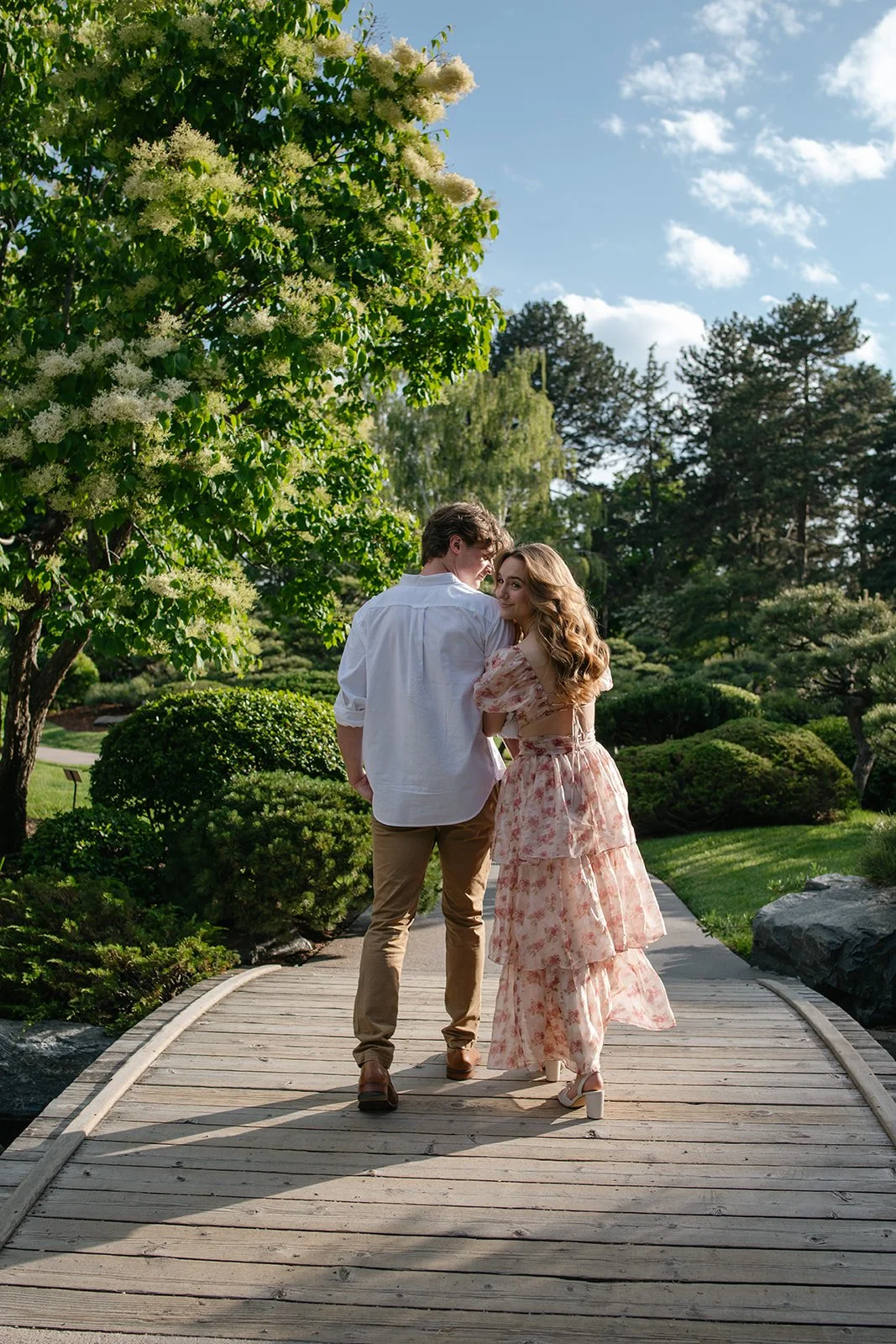 a couple walking on a bridge together at the Botanic Gardens in Denver