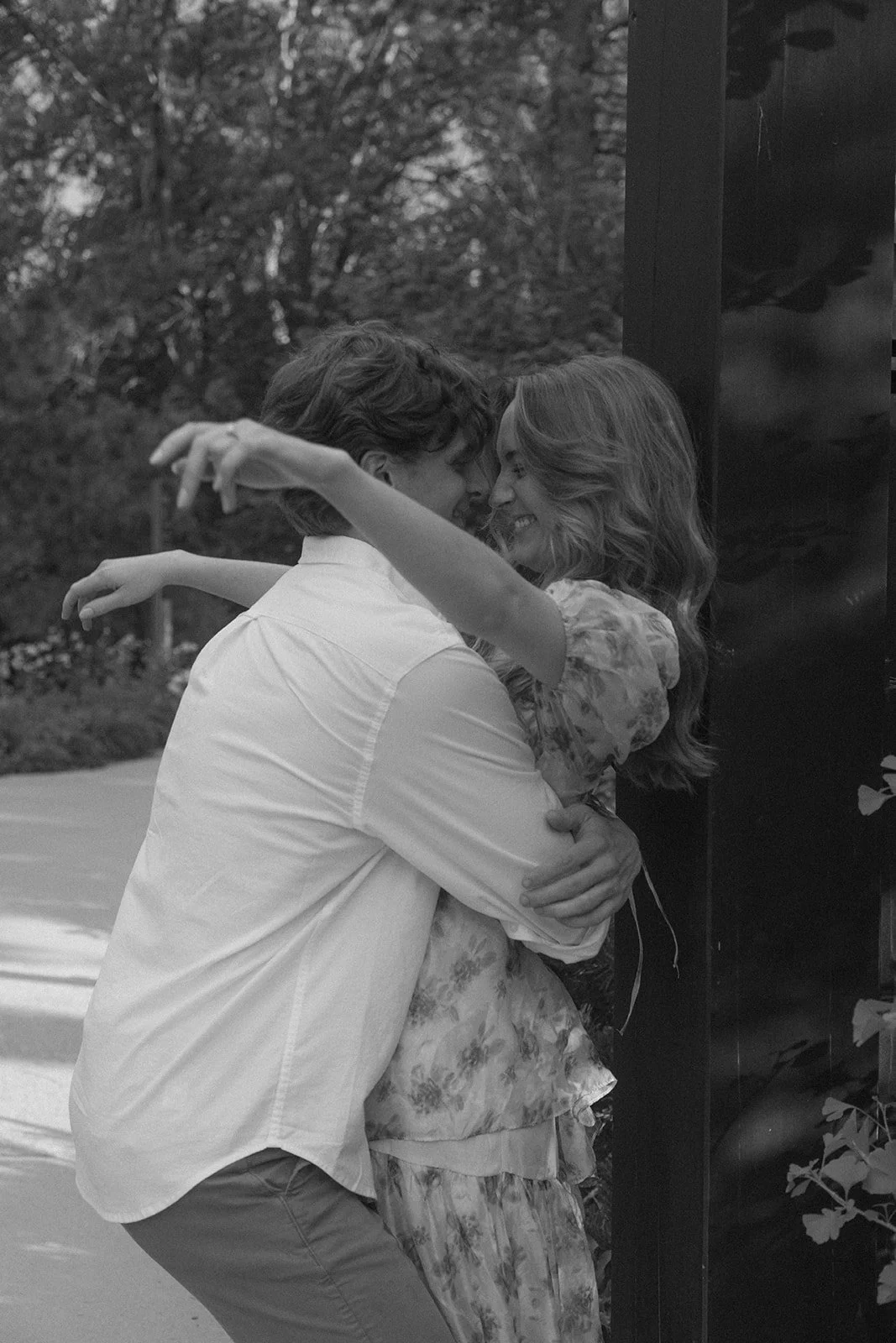 a man beginning to pick up a woman during their Denver engagement photos