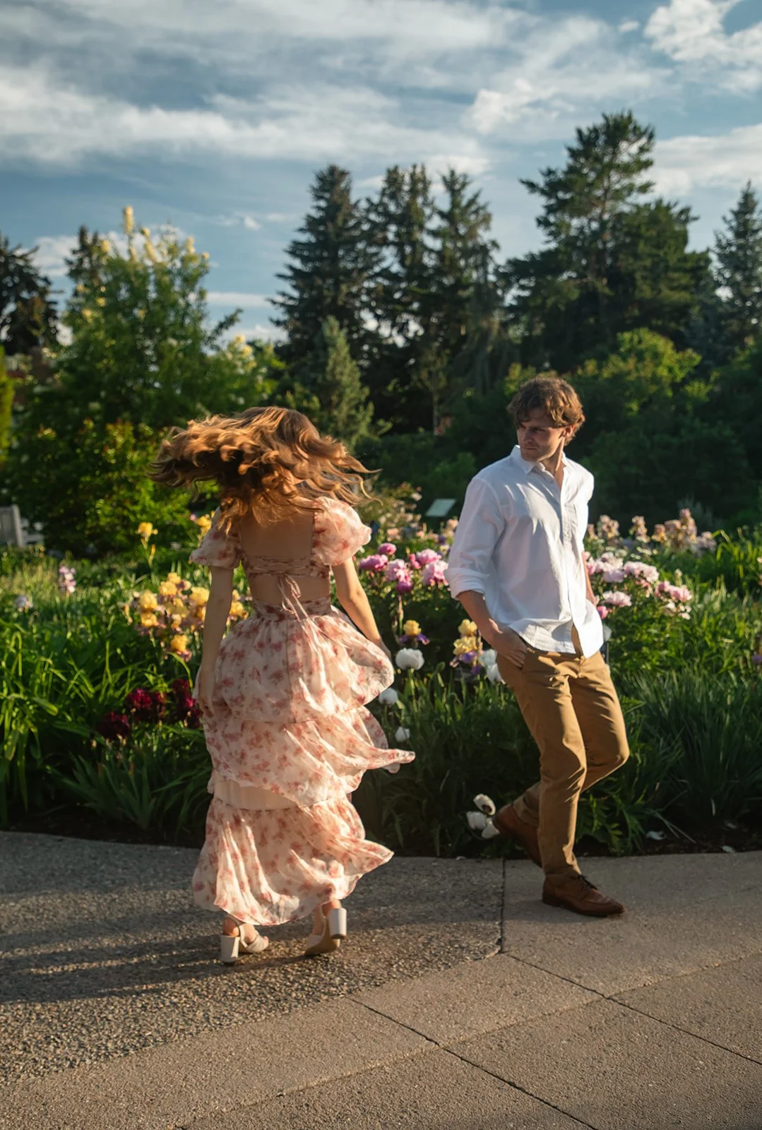 a couple playing together in the garden during their Denver engagement photos