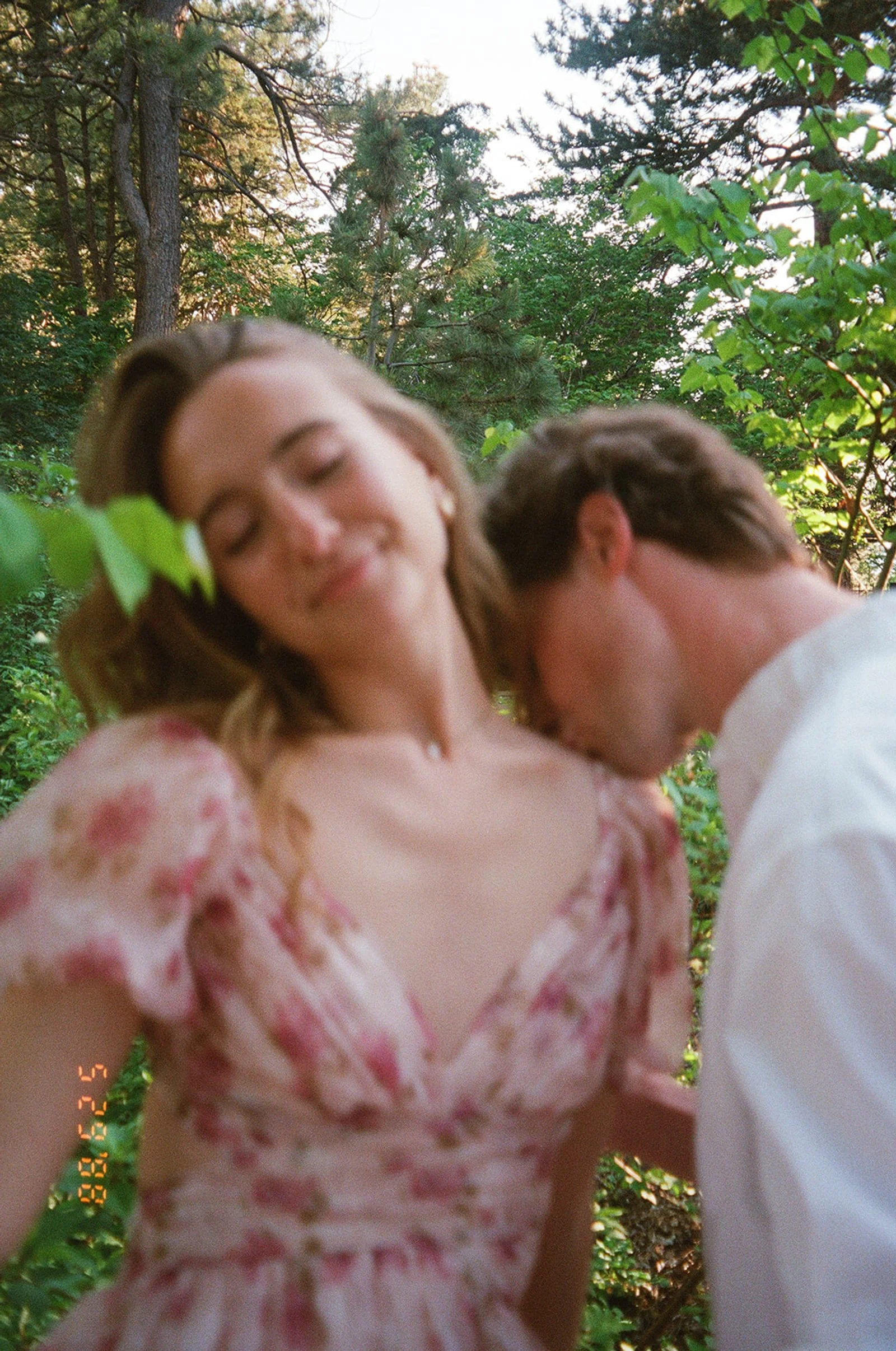 a man kissing a woman's shoulder taken by a Denver engagement photographer on film