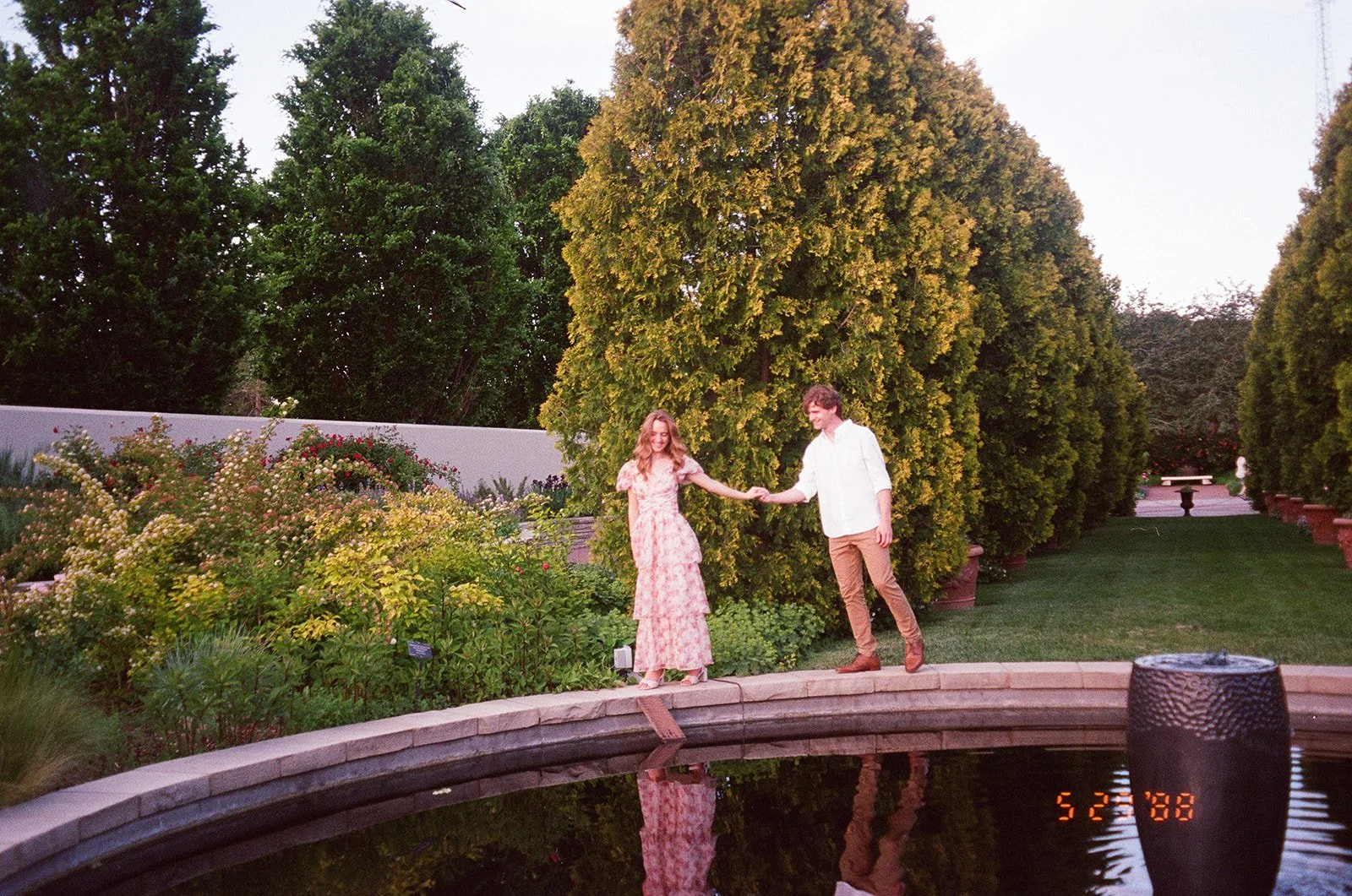 a film engagement photo by the fountain at the Botanic Garden 