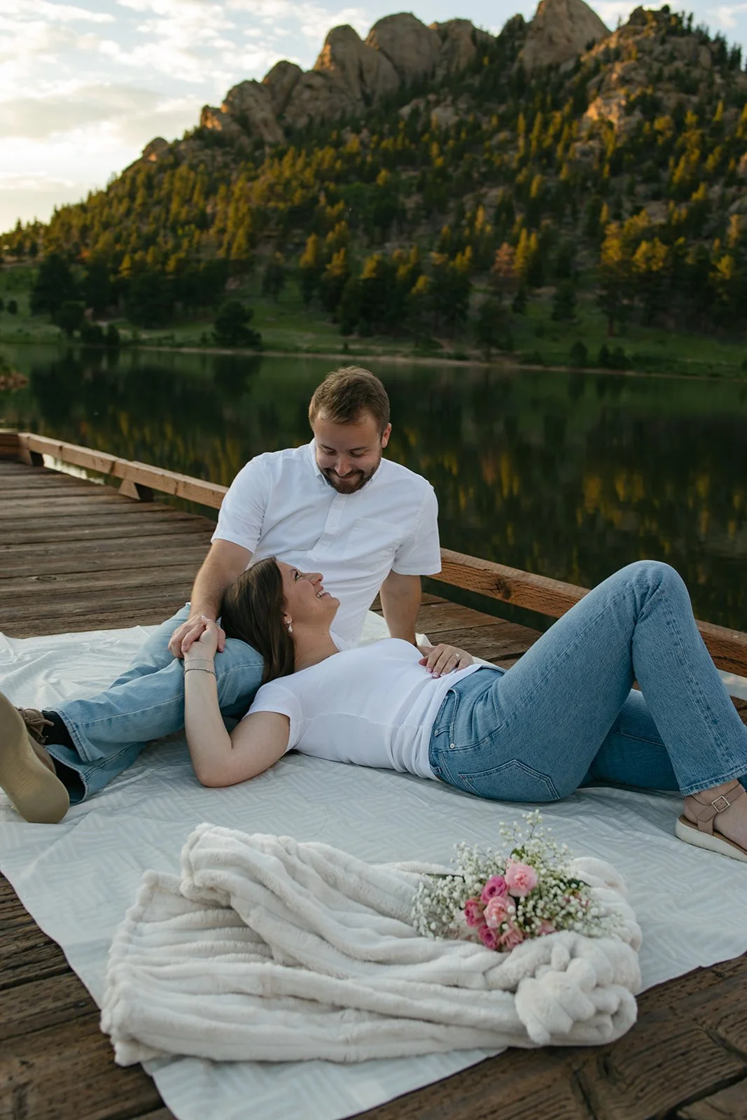 a coupe hangin out on a dock at a beautiful lake Engagement Photo Location in Colorado