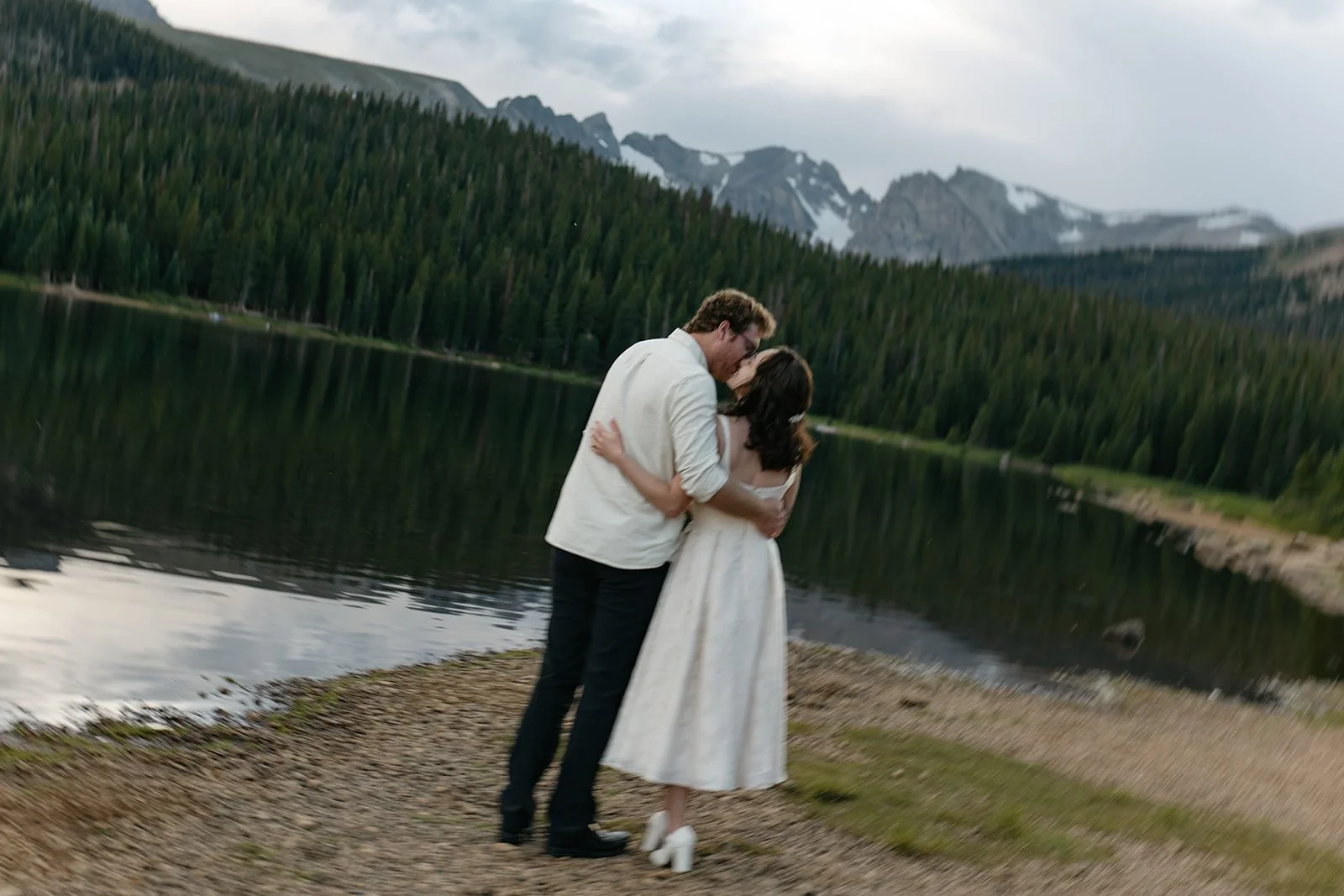 a couple kissing by the lake at one of my favorite Engagement Photo Locations in Colorado