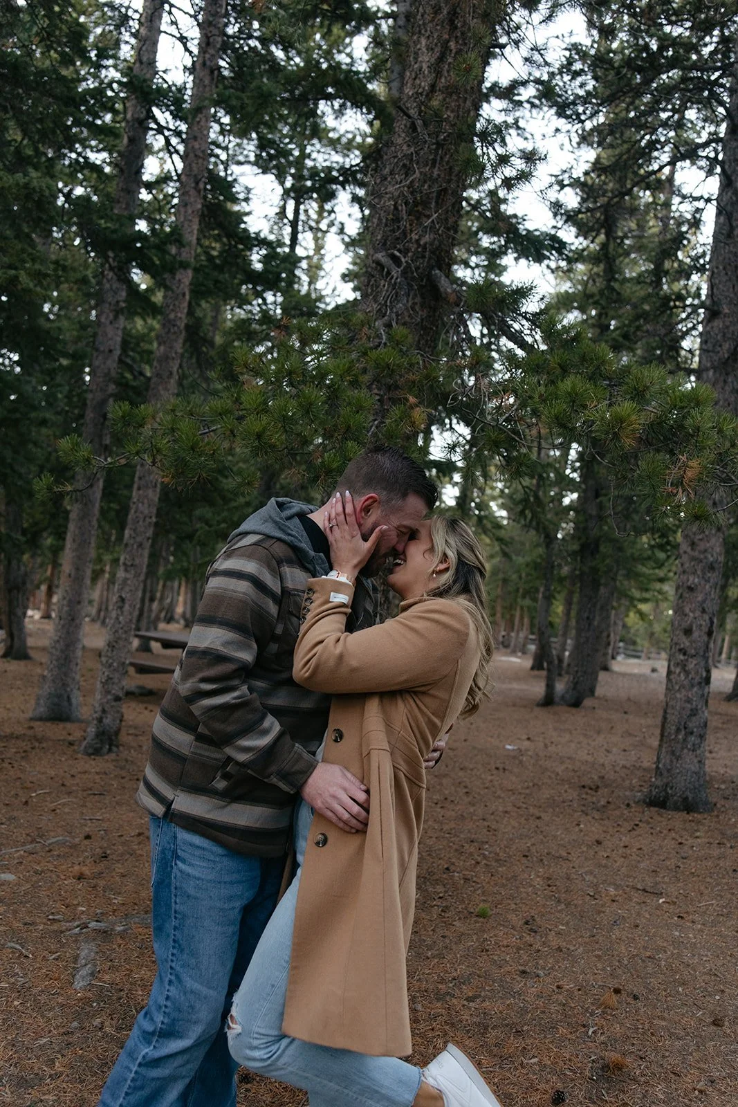a couple kissing in the woods at one of my favorite Engagement Photo Locations in CO