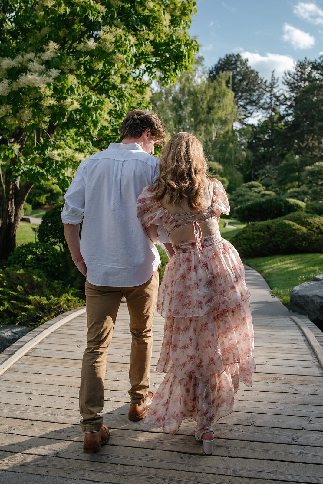 a couple walking across a bridge during their Colorado engagement photos