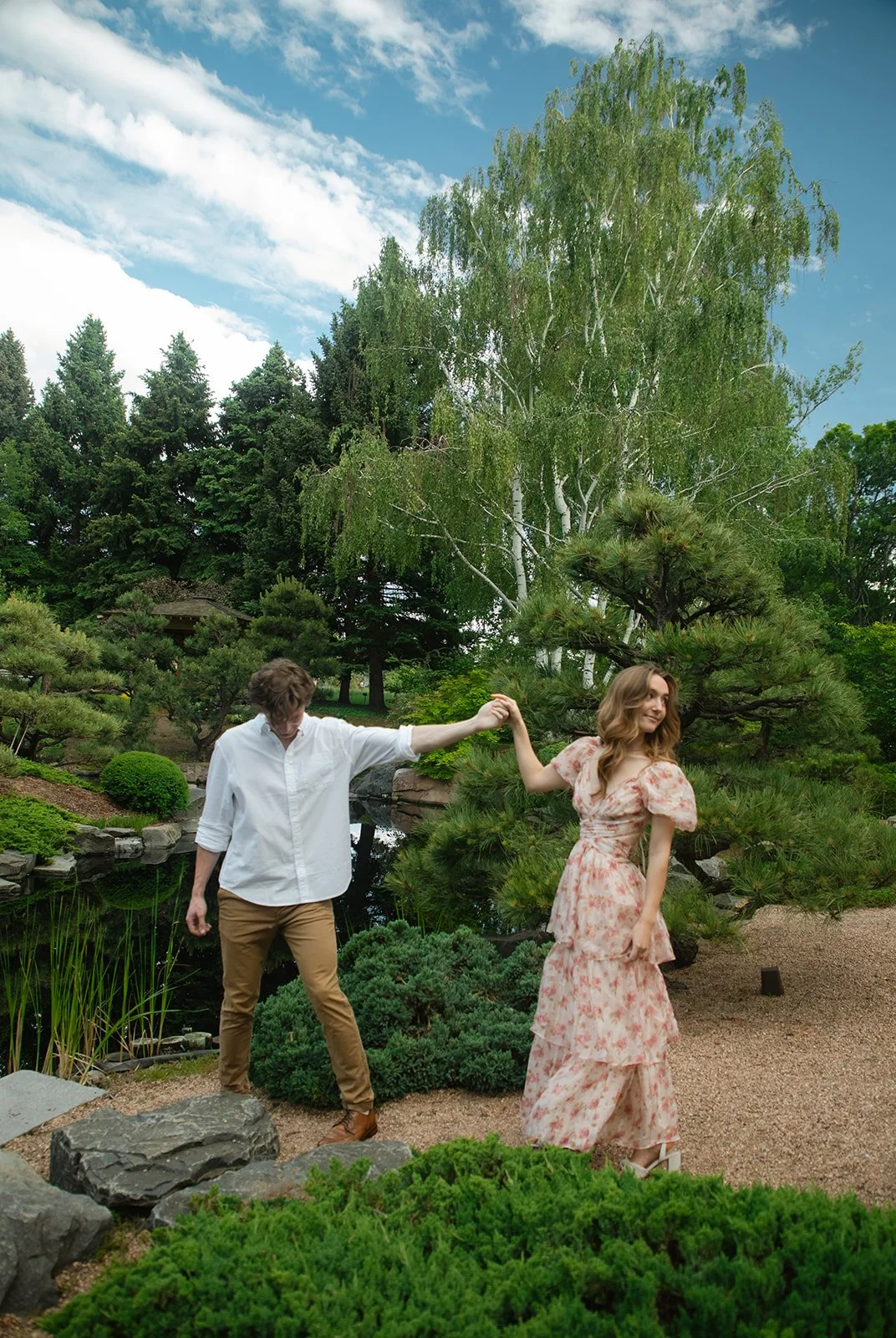 a couple dancing by a garden pond at a favorite Engagement Photo Location in CO