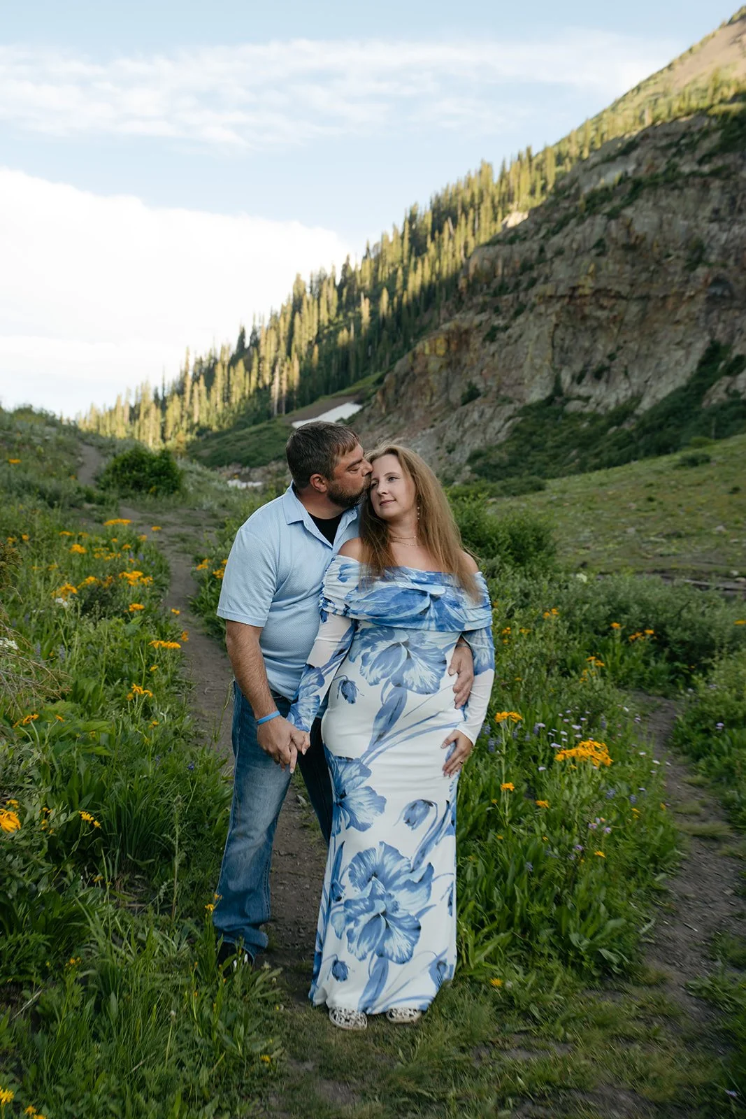 a couple standing together in the mountains at a Colorado Engagement Photo Location