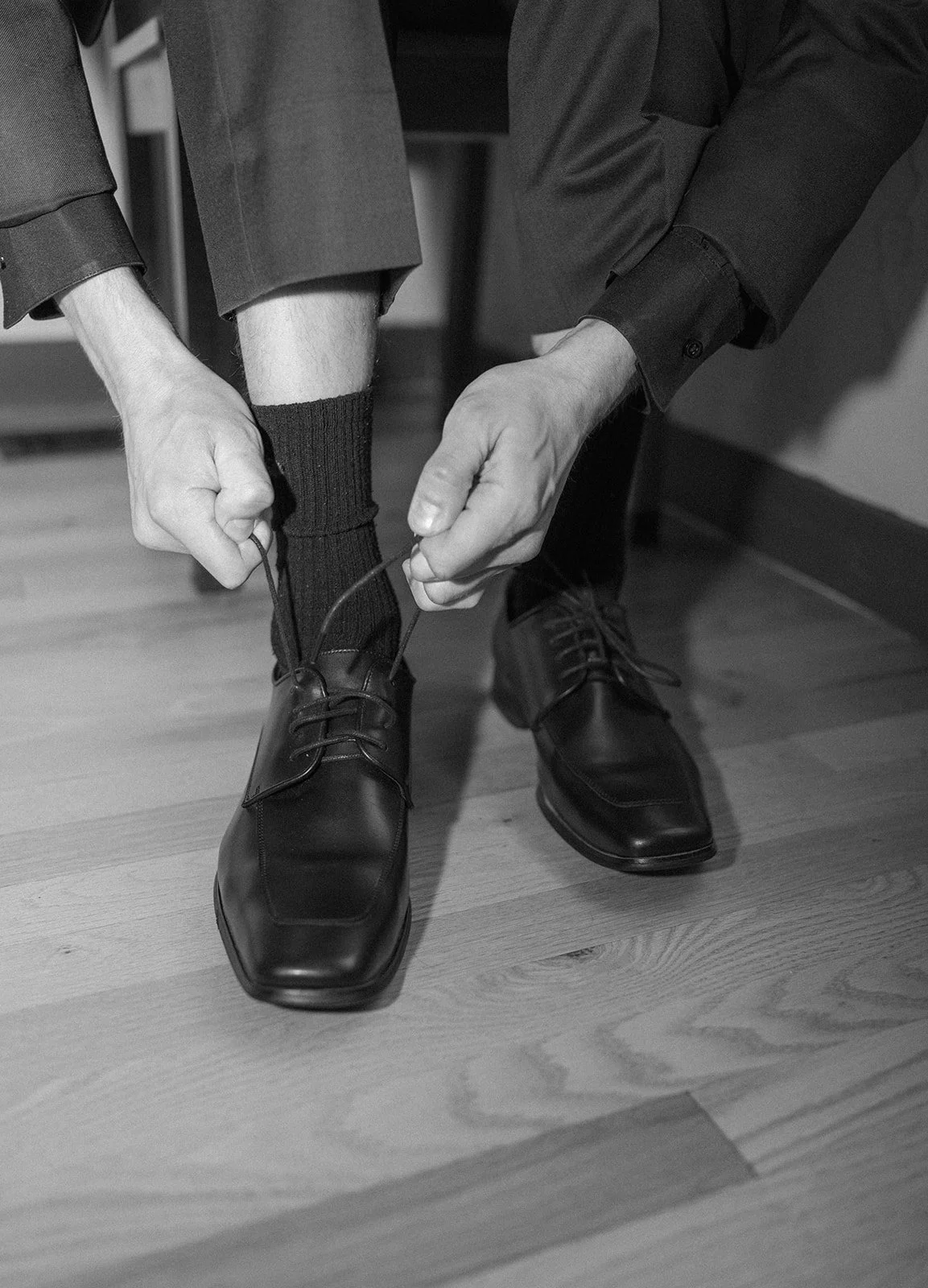 the groom putting his shoes on at a Micro Wedding Venue in CO