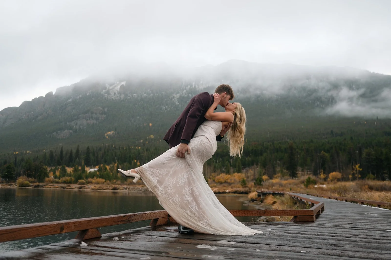 a man dipping his bride as they kiss during their Colorado elopement