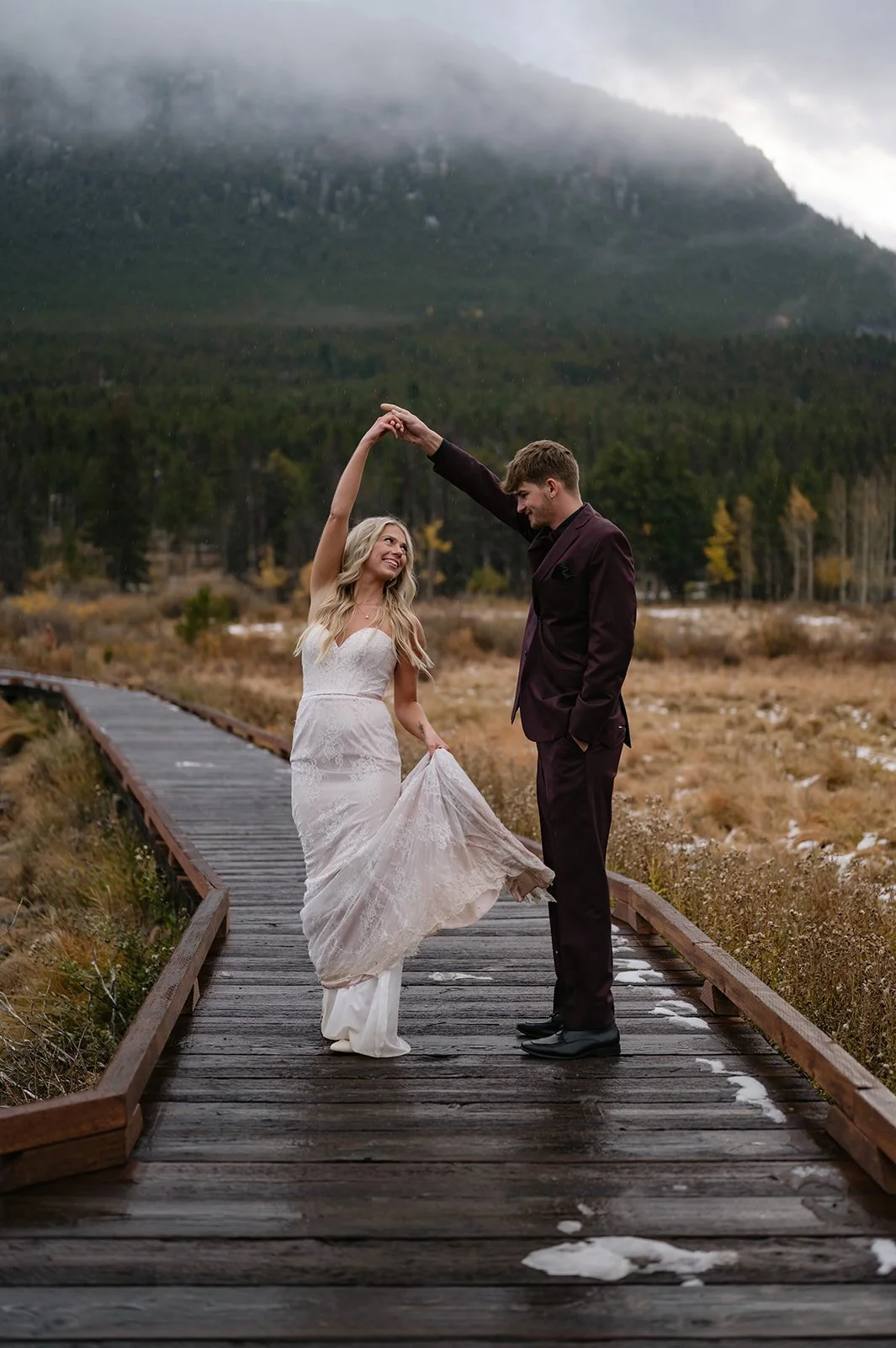a man spinning a woman during their Colorado mountain elopement