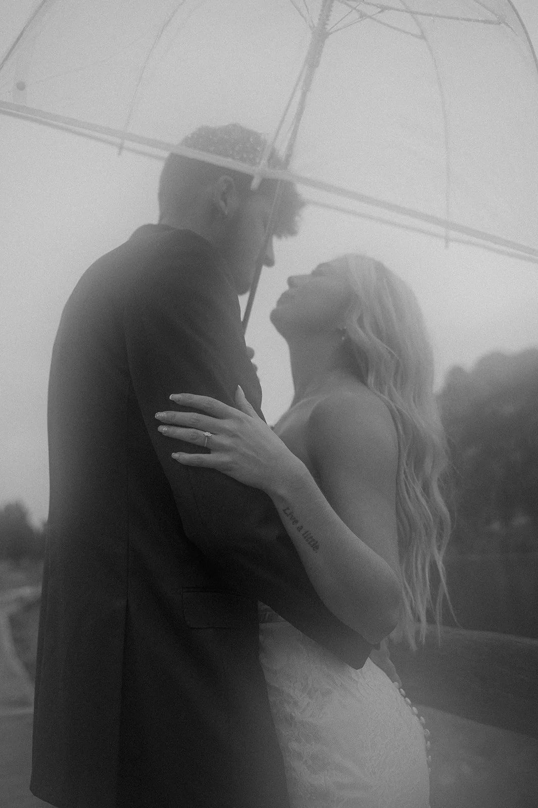 a bride and groom underneath an umbrella during their elopement 