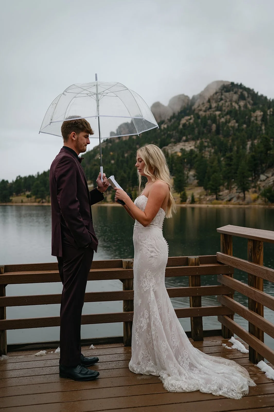 bride and groom during their private vows, on a dock in Colorado
