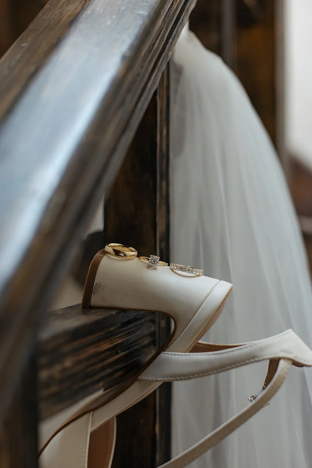 a heel hanging on a ledge with rings along the heel for Wedding Detail Photos