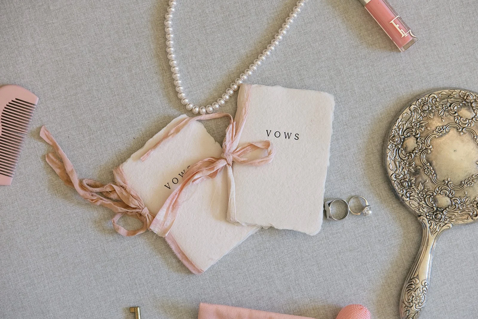 vow books, jewelry and an old mirror laid out for Wedding Detail Photos