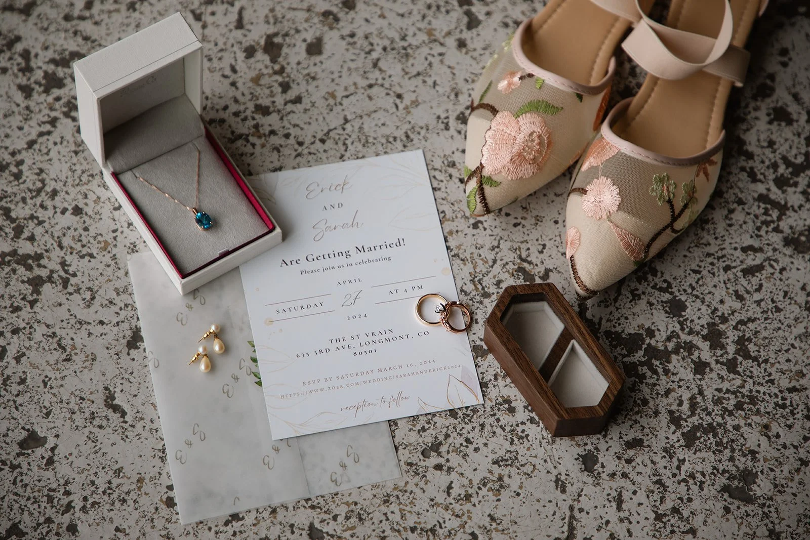 a bride's details along with their wedding invitation laid out for Wedding Detail Photos