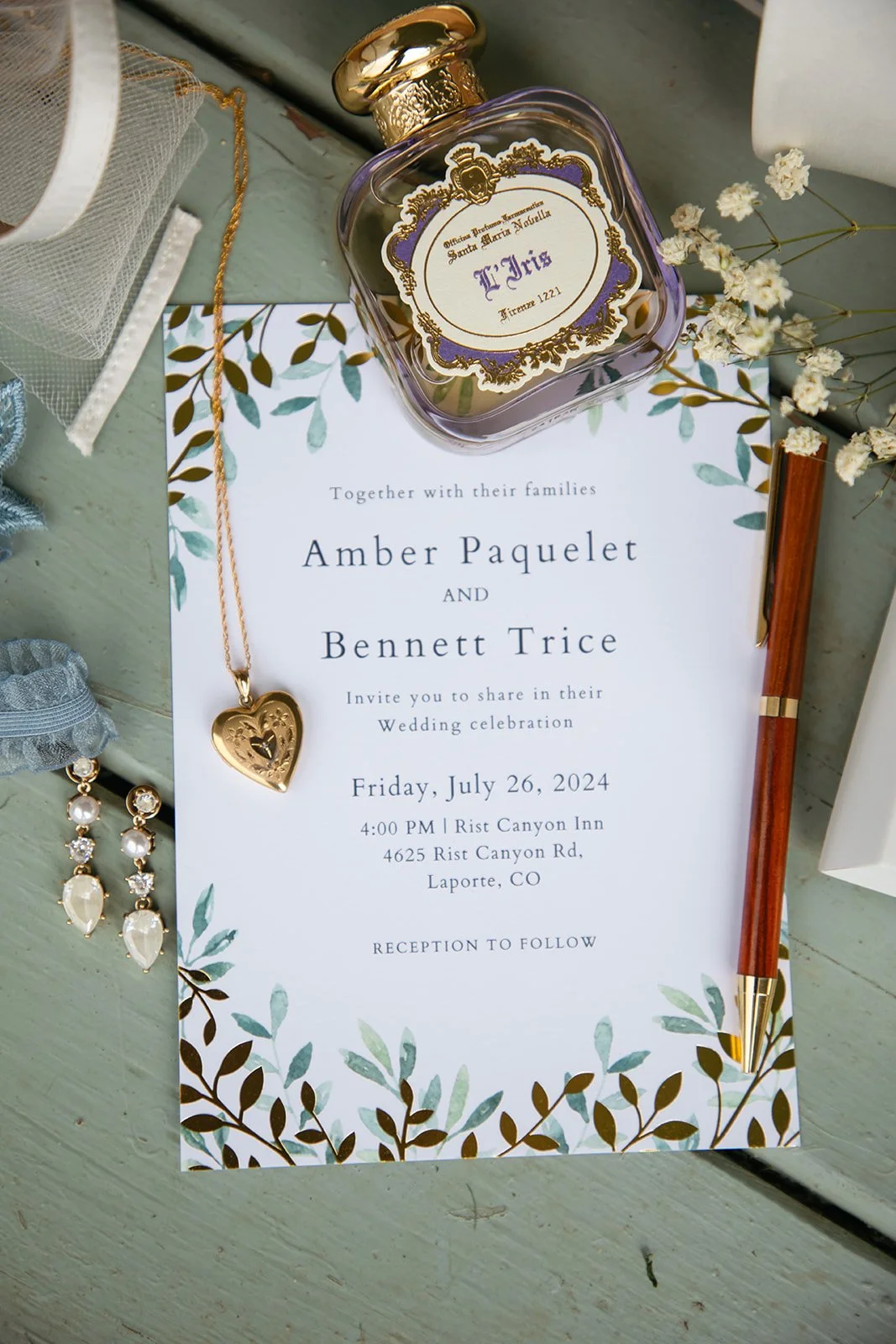 Wedding Detail Photos with the wedding invitation, perfume, jewelry and florals 